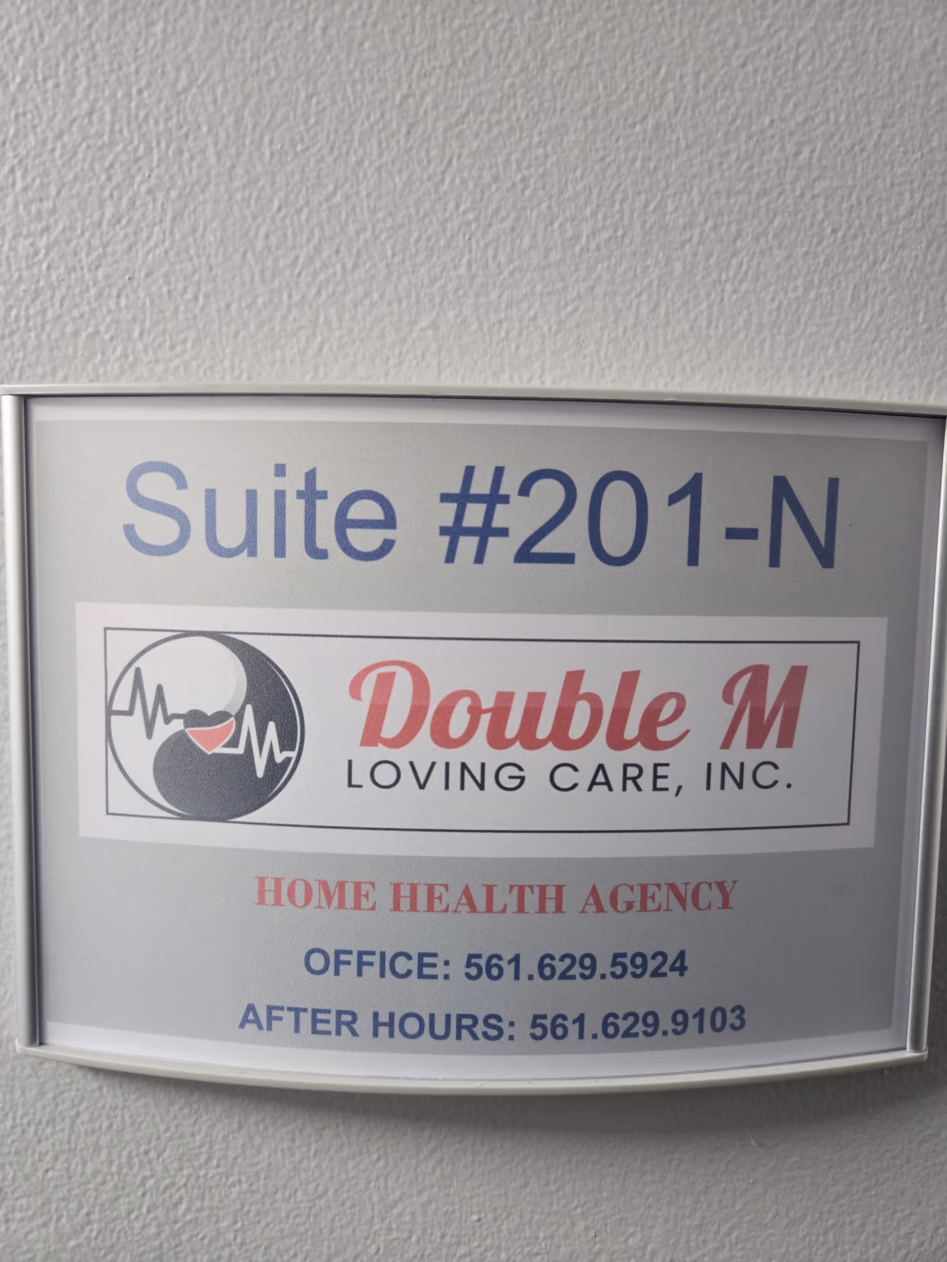 Sign reads Suite #201-N for Double M Loving Care, Inc., home health agency.