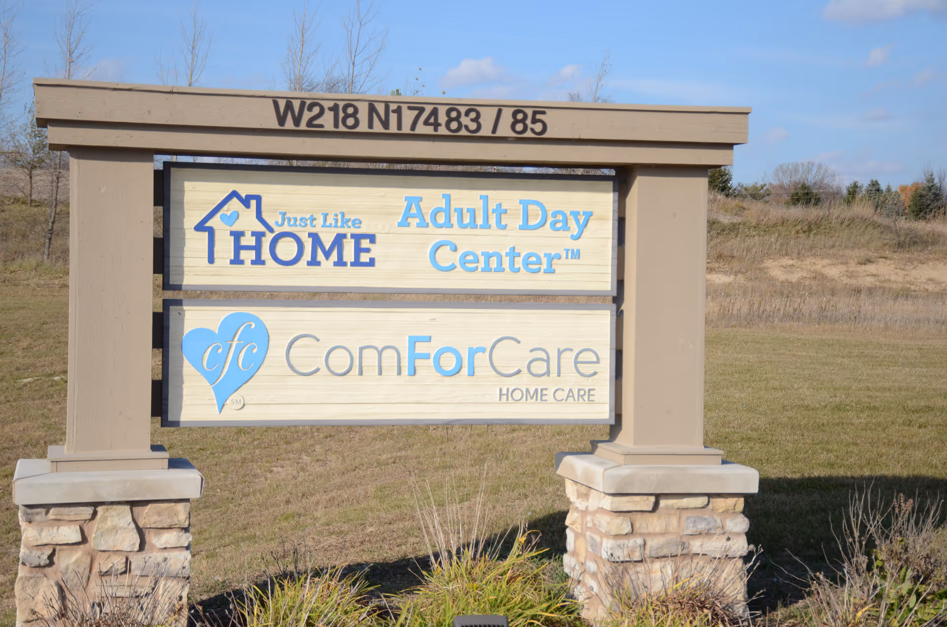 Outdoor sign for Just Like Home Adult Day Center with ComForCare logos.