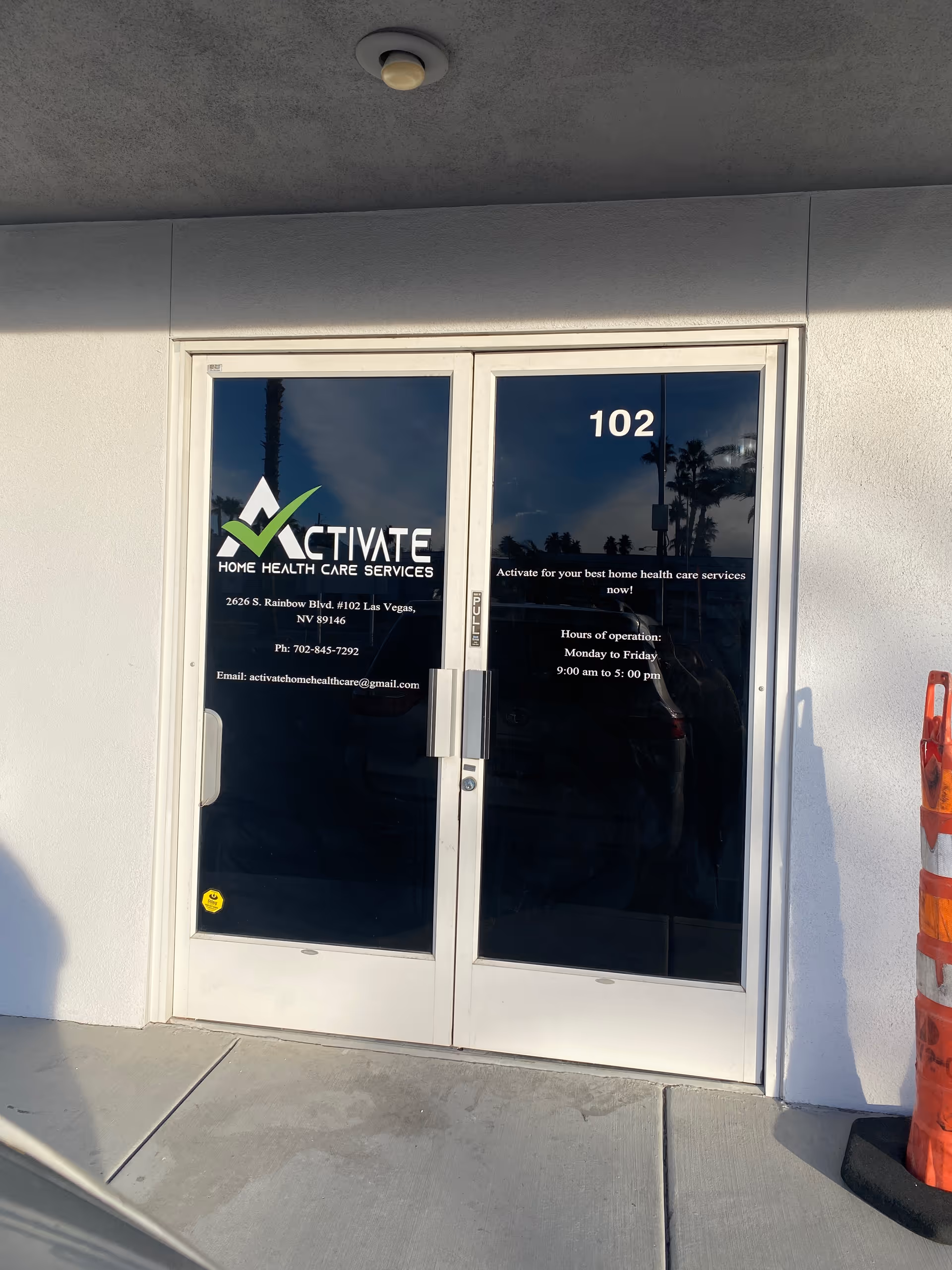 Glass doors display Activate Home Health Care Services signage at the building entrance.