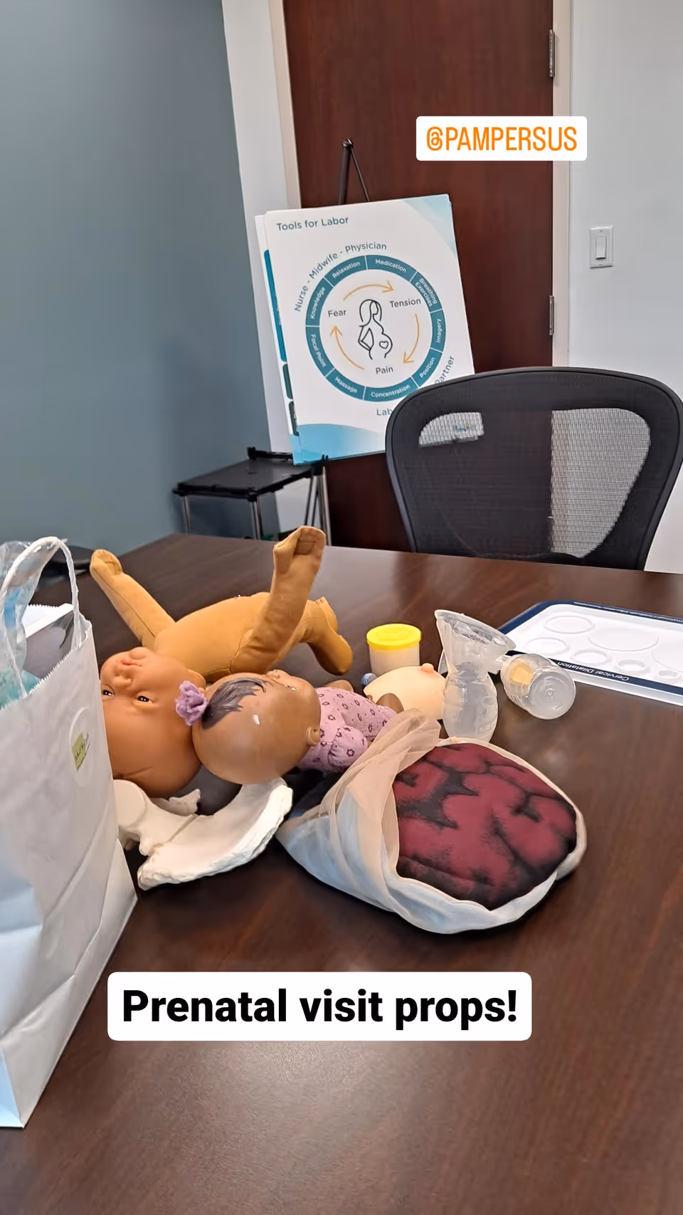 Table with baby dolls and prenatal props in a clinical teaching setup.