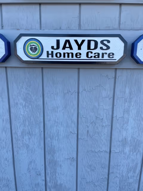 Exterior wall with a JAYDS Home Care sign and circular logo.