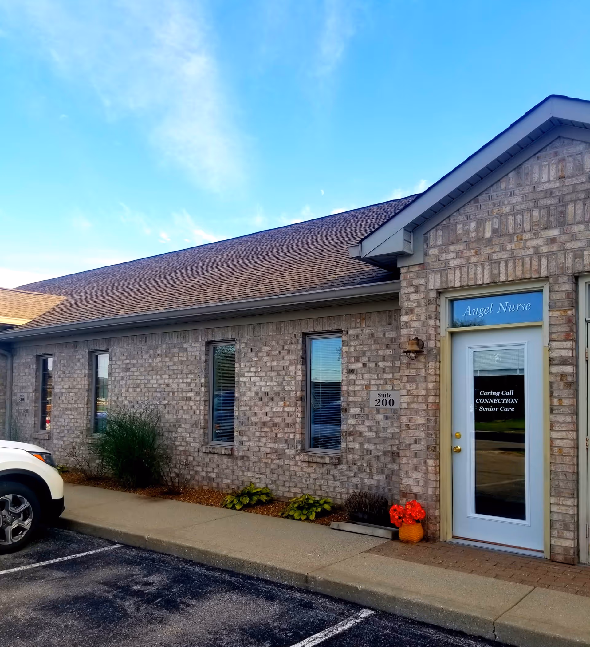 Brick exterior of Angel Nurse facility with front door and landscaping.