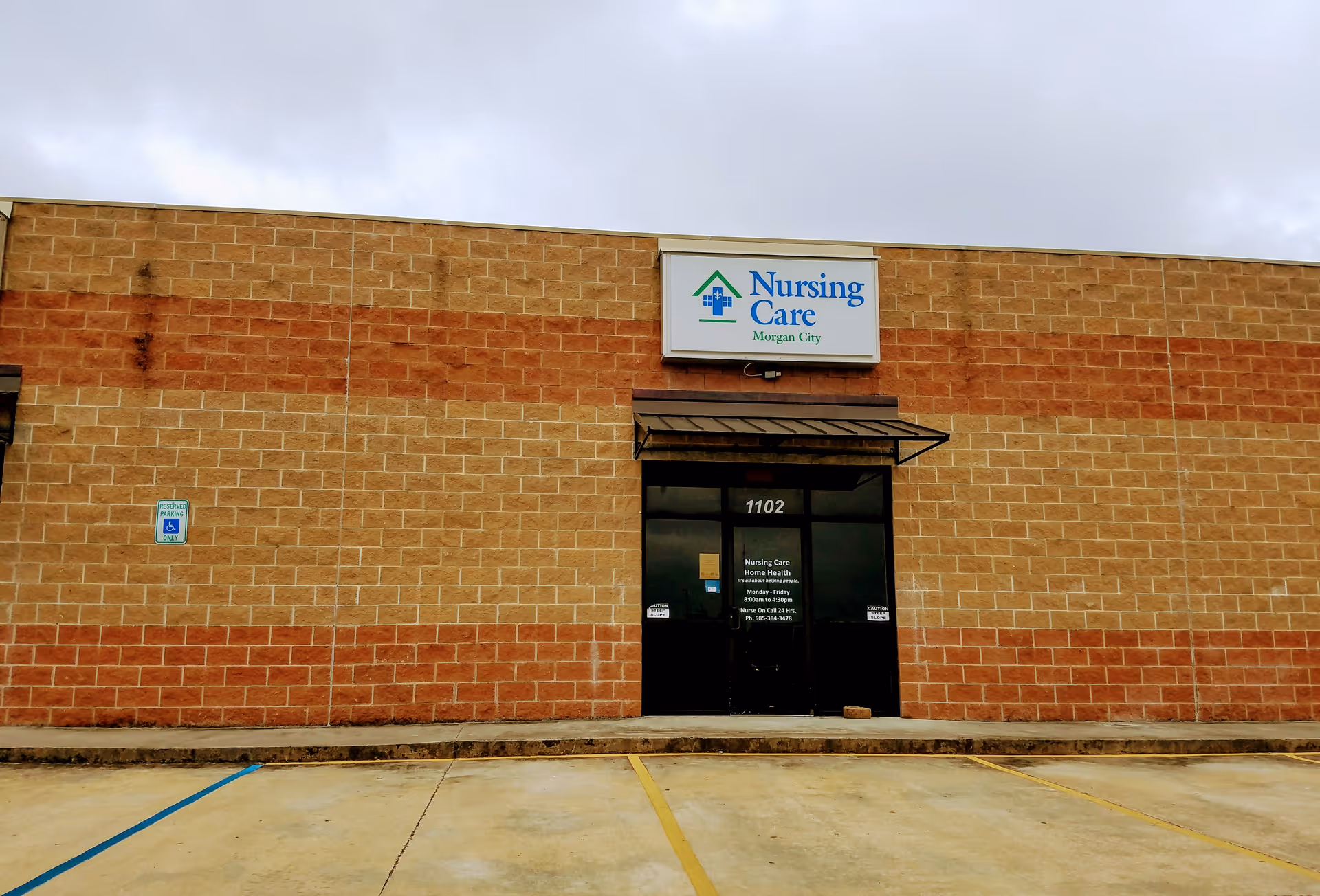 Exterior view of a Nursing Care Home Health facility entrance with sign.