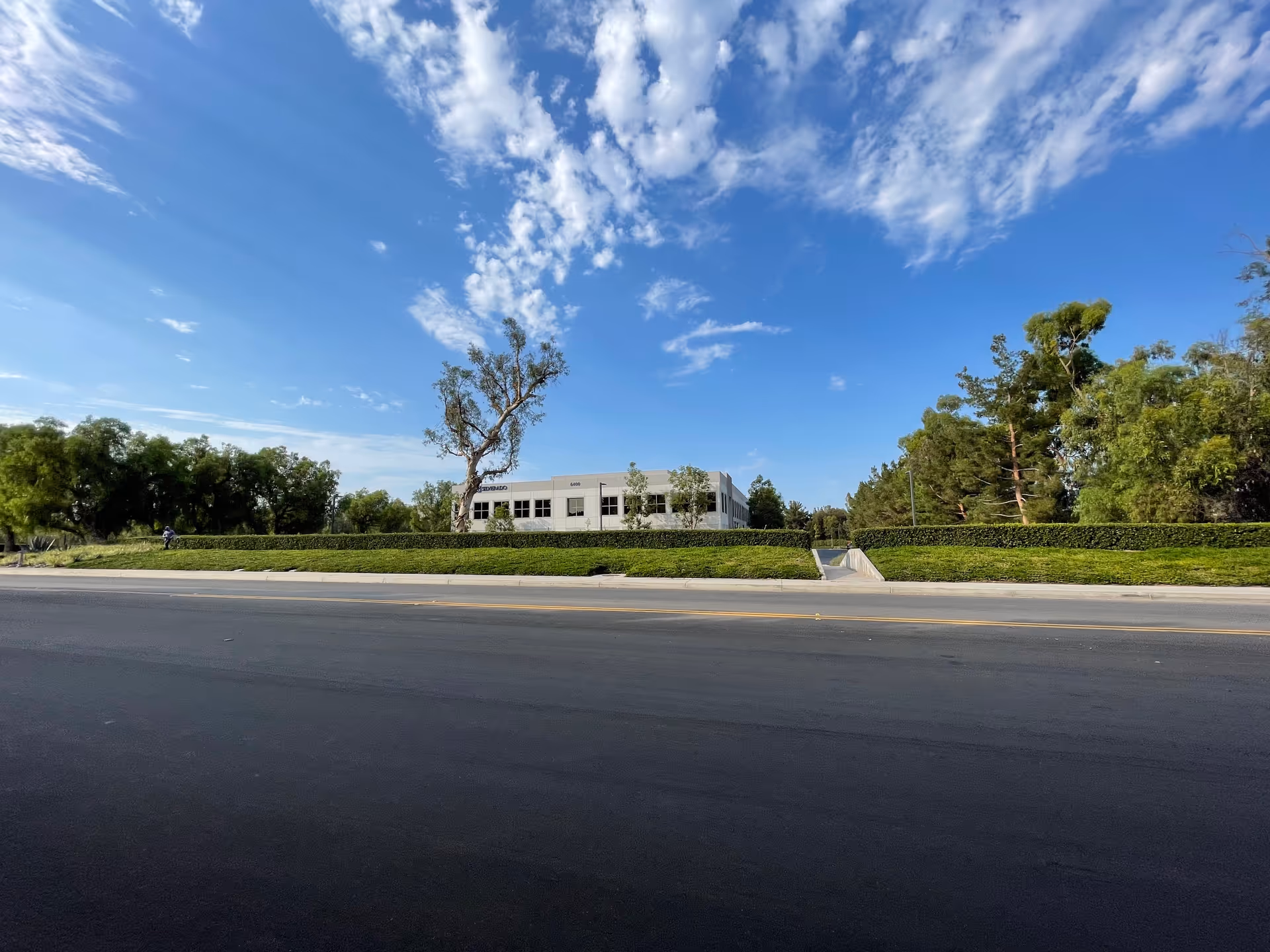 Exterior view of Silverado Senior Living Sierra Vista along a tree-lined street.