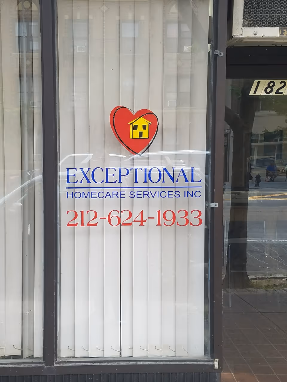 Front glass entrance of Exceptional Home Care Services with heart logo and phone number.