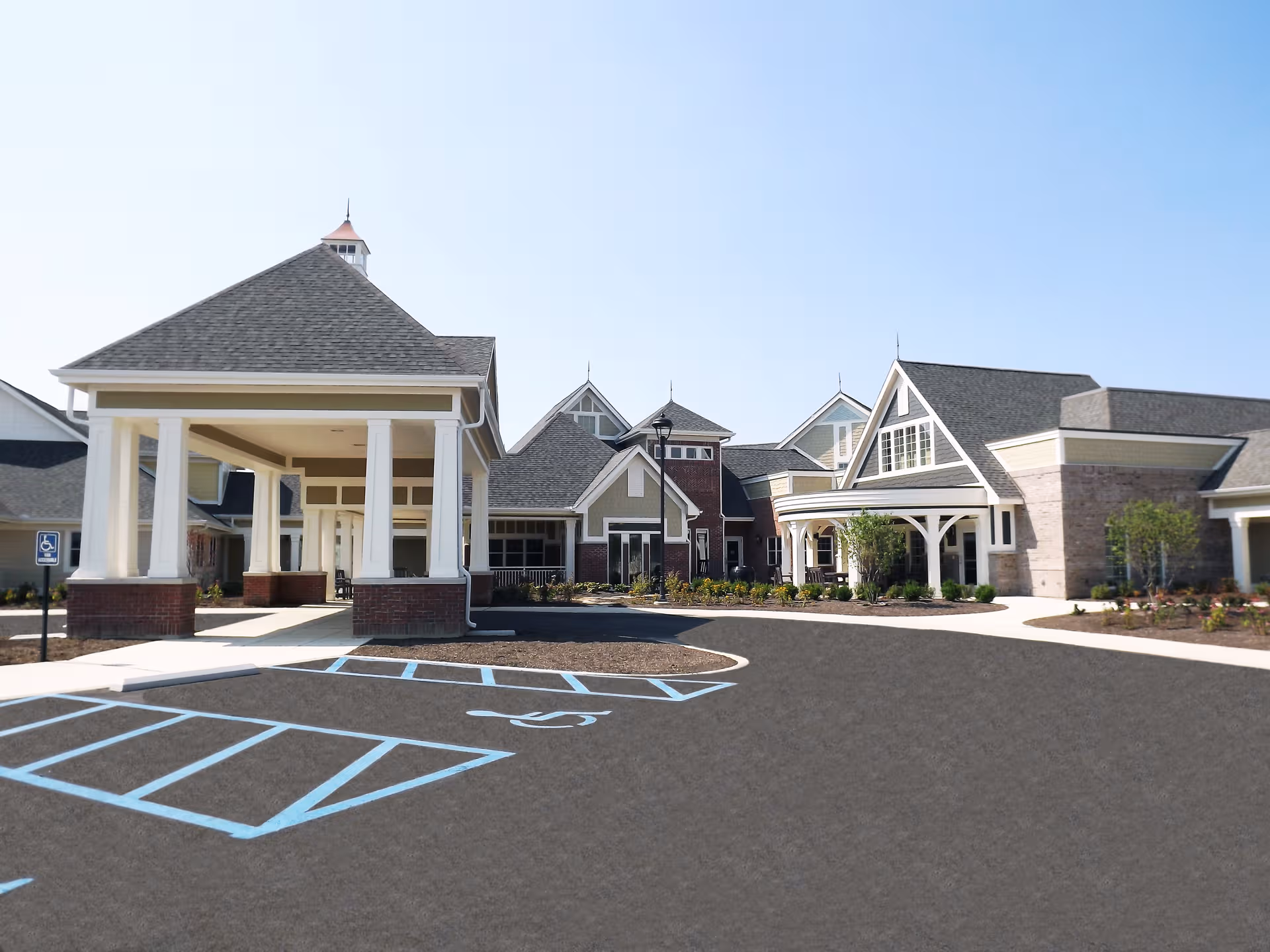 Exterior view of Fox Run Manor with a porte-cochere and accessible parking.