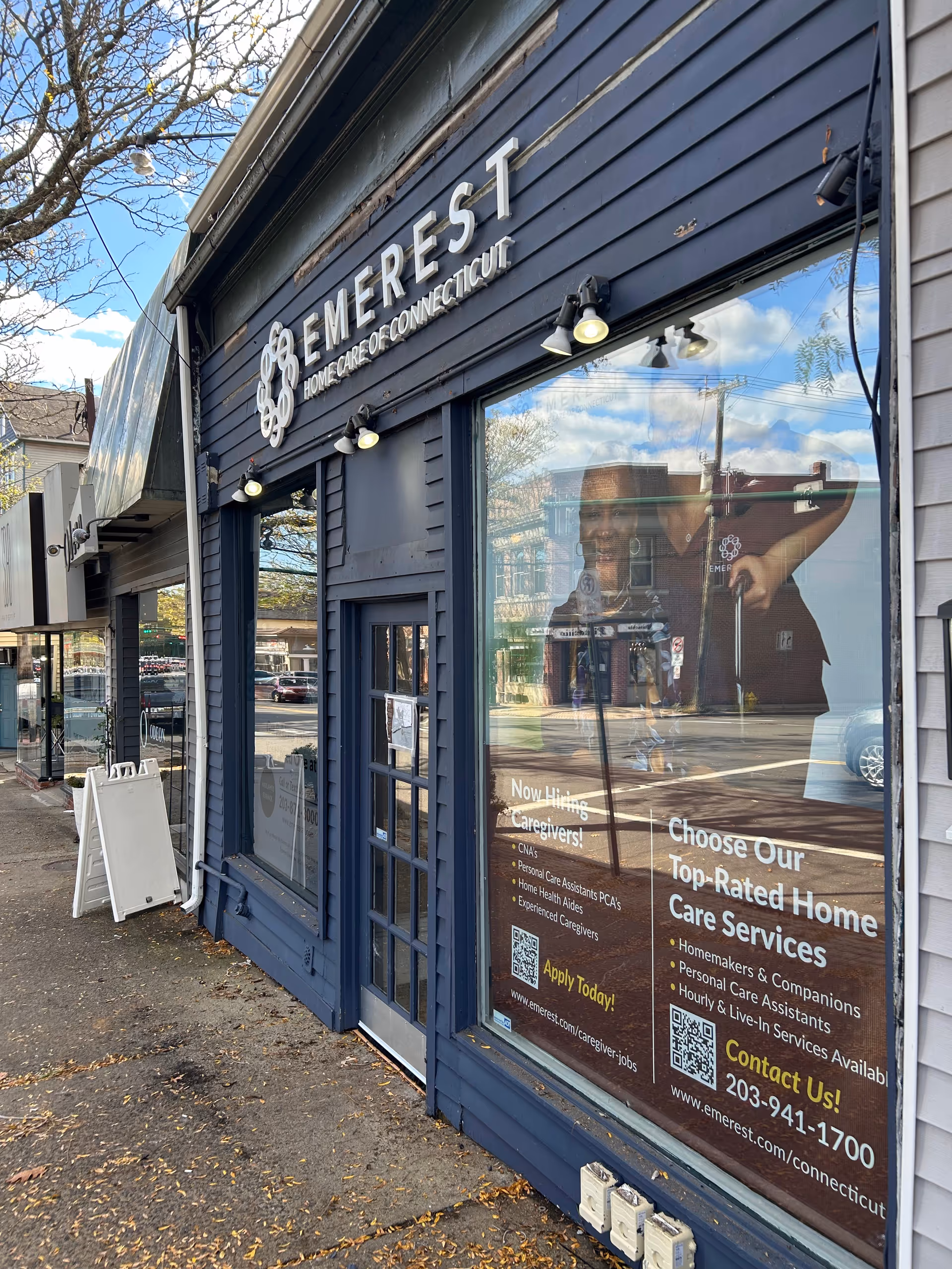 Blue storefront of Emerest Home Care of Connecticut with window and signage