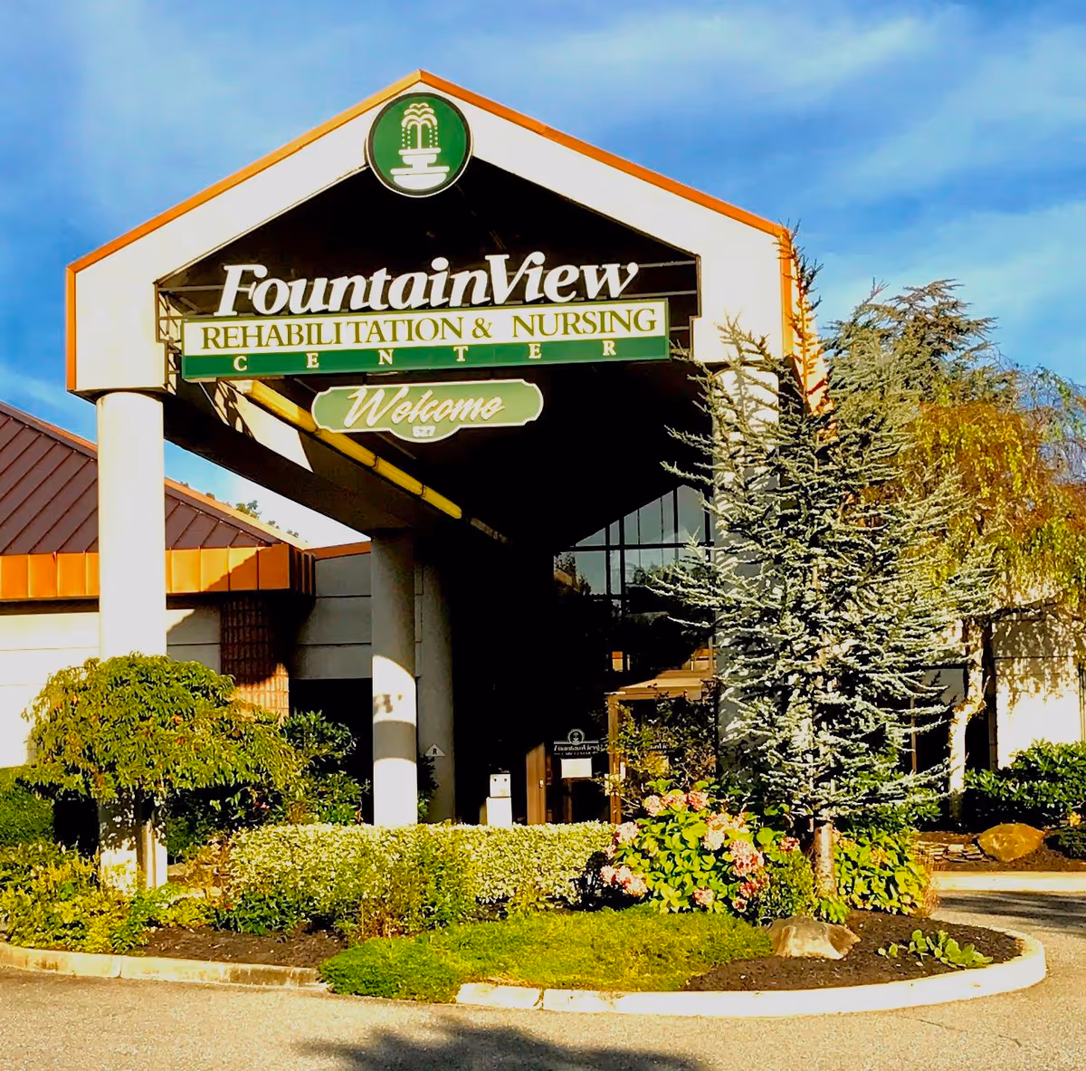 Exterior view of Fountain View Rehabilitation & Nursing Center entrance with landscaping.