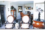Interior living room with ornate chairs, a dining area, and wall decor.