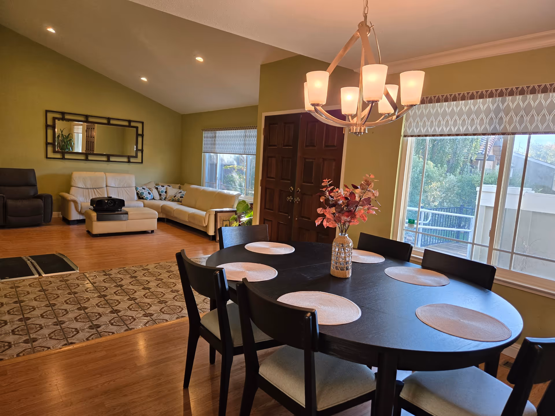 An open-plan living and dining area with a dark table and beige seating.