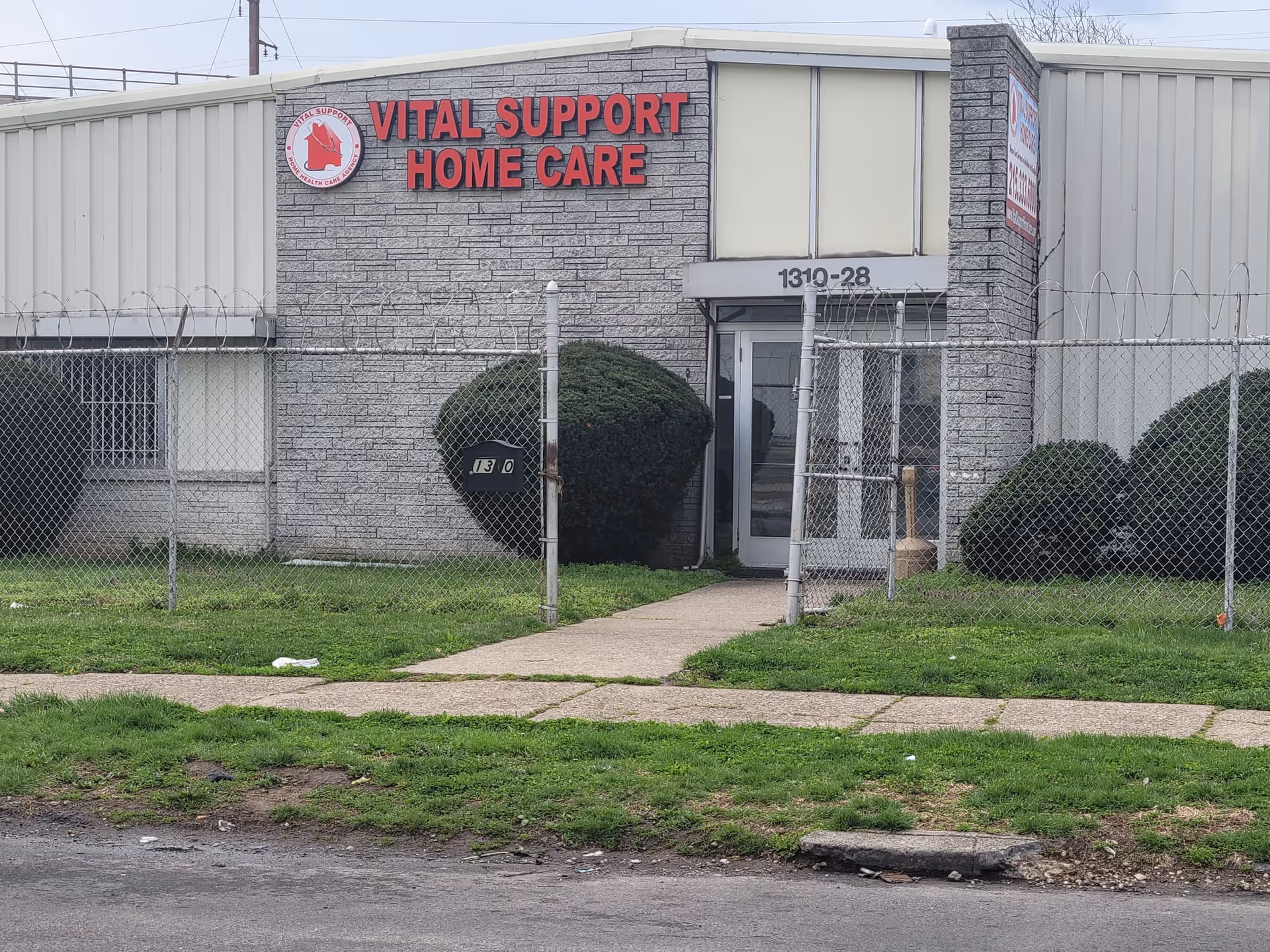 Front view of Vital Support Home Care facility with gated entrance and sign