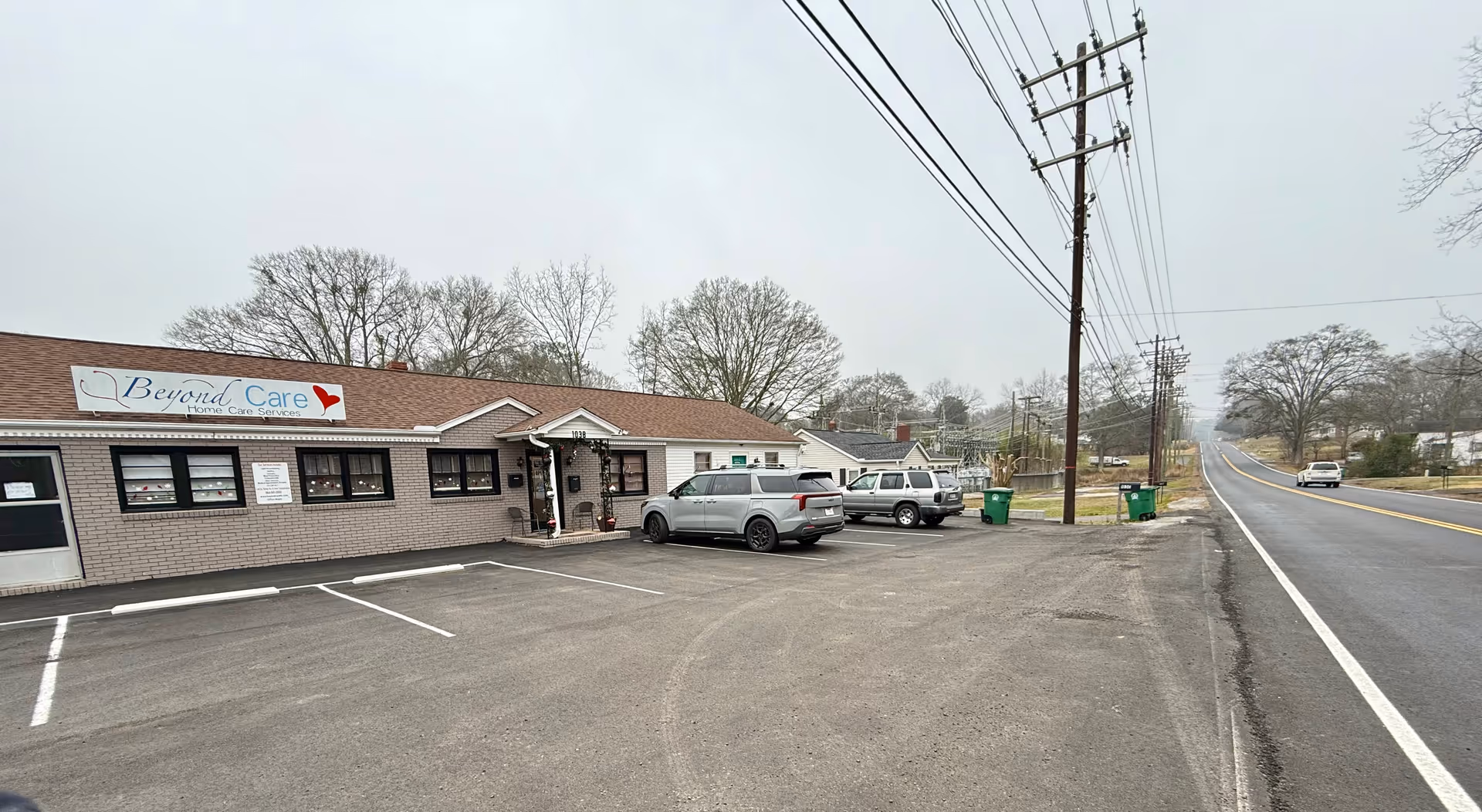 Beyond Care single-story facility with parked cars along a road.
