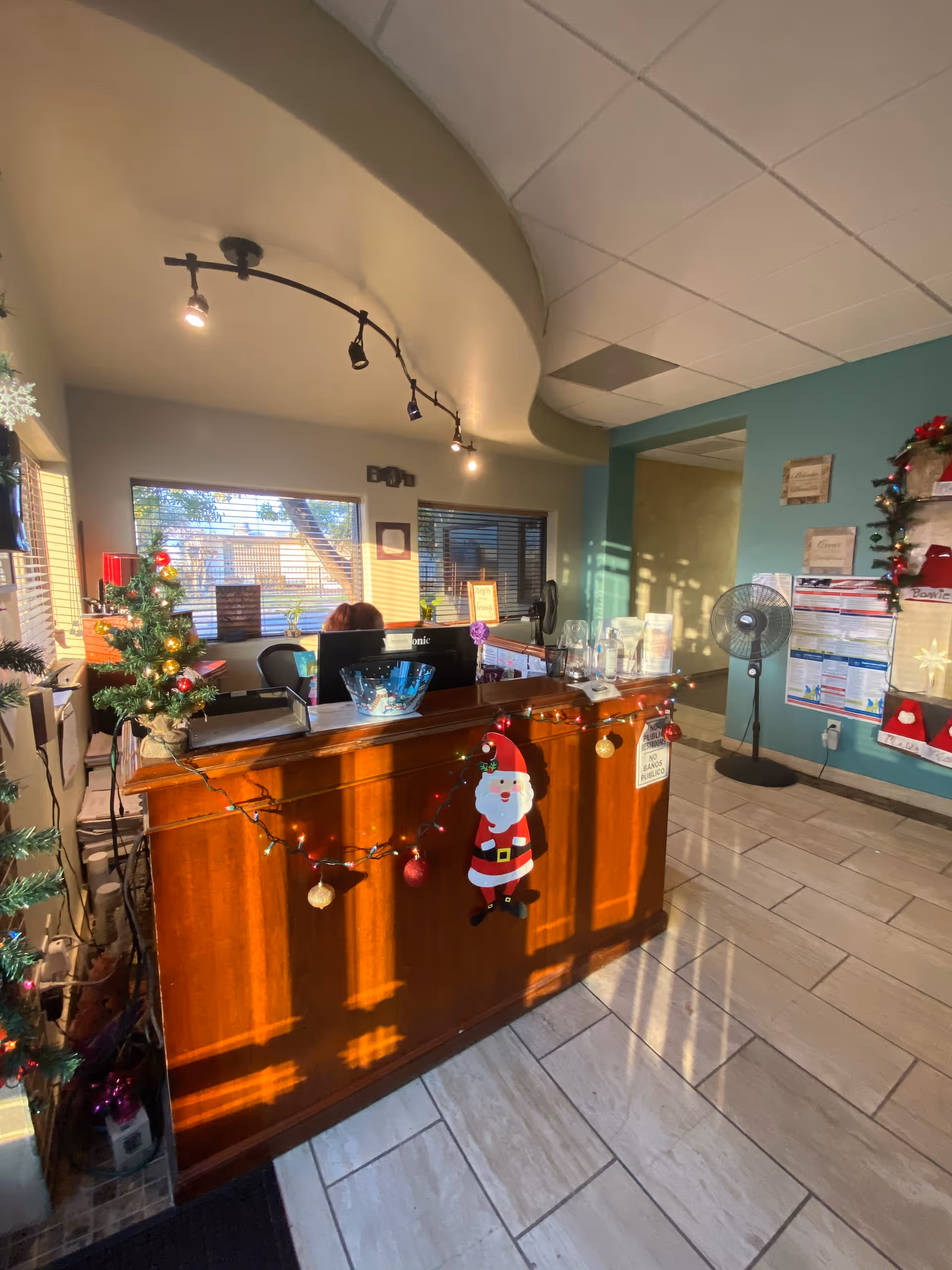 Reception desk inside a senior living facility decorated for Christmas.