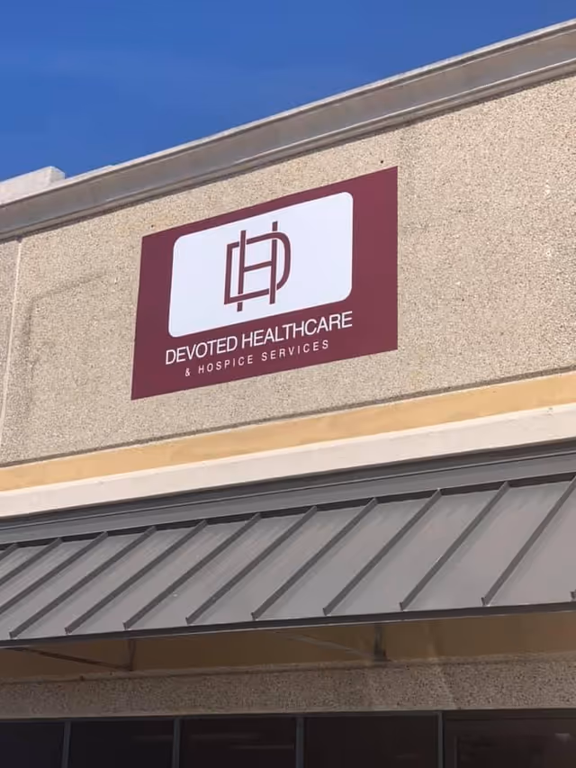 Exterior of building with Devoted Healthcare & Hospice Services sign on wall.