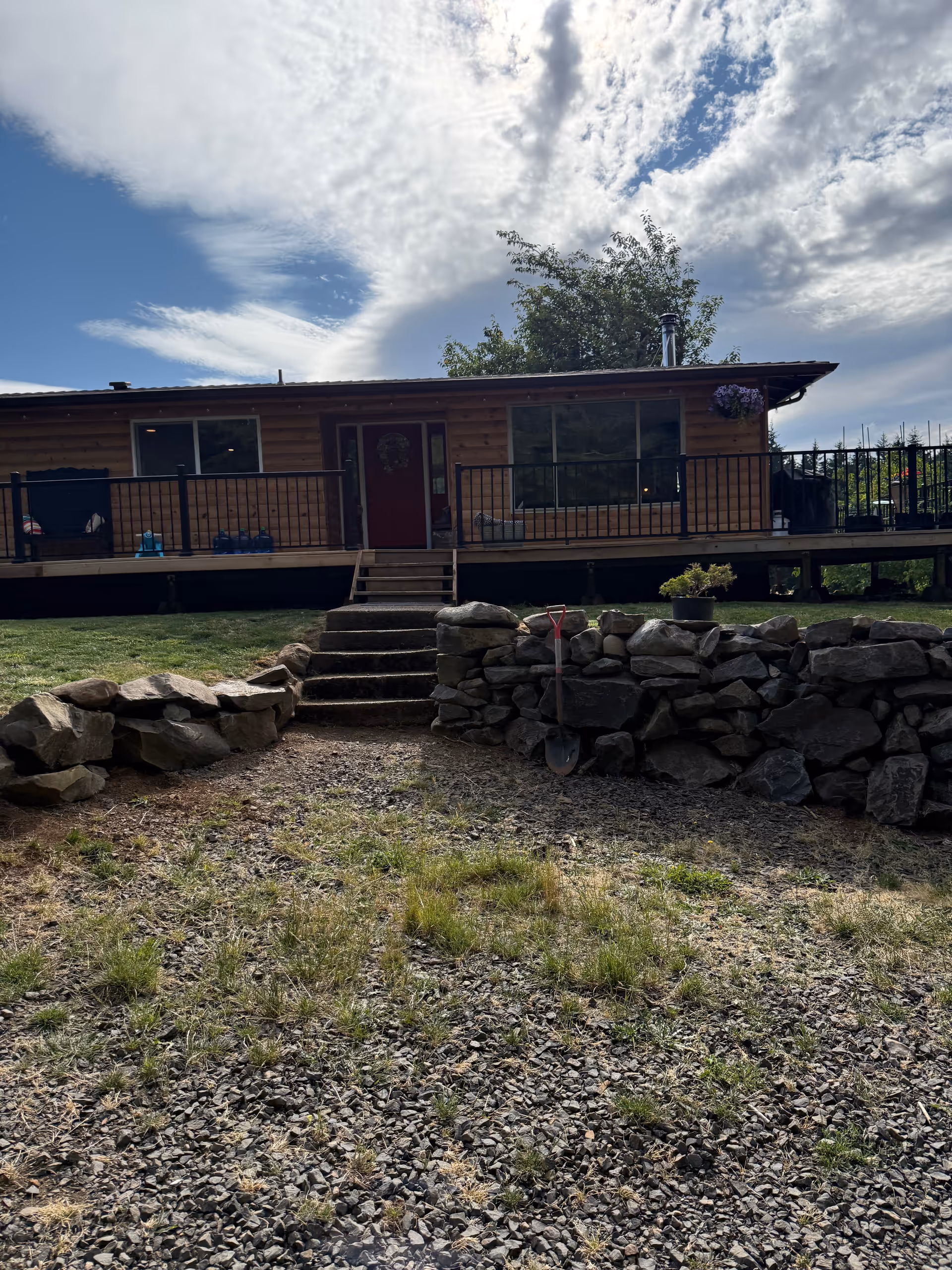 Front view of Turbyne Care Home: a single-story wooden building with a deck and stone steps.