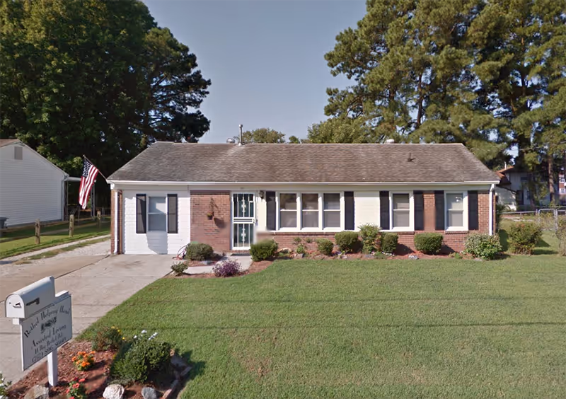 Single-story brick facility with manicured lawn, shrubs, and a front entrance, labeled Bethel Helping Hands.