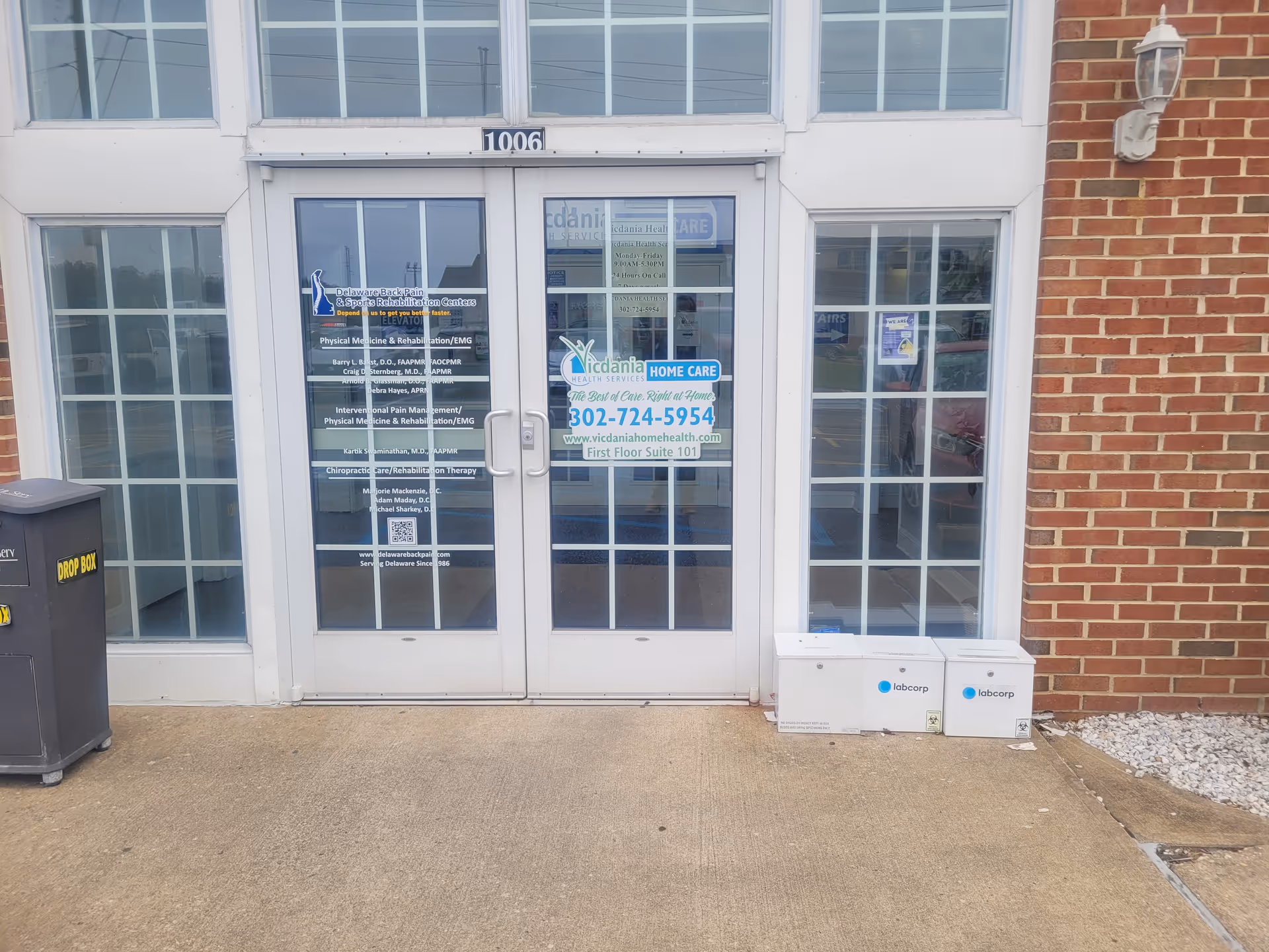 Front entrance of VICDANIA Health Services LLC with glass doors and brick exterior.
