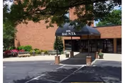 Exterior view of Sayre Christian Village entrance with brick facade and black awning.