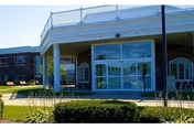 Front entrance of Hathaway Manor Extended Care with glass doors, brick exterior, and covered entry.