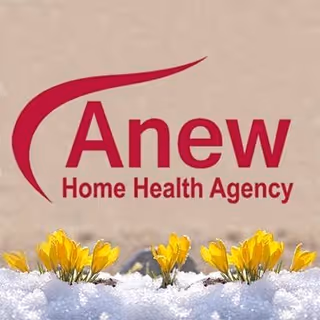 Anew Home Health Agency logo on an exterior wall with yellow flowers in the snow.