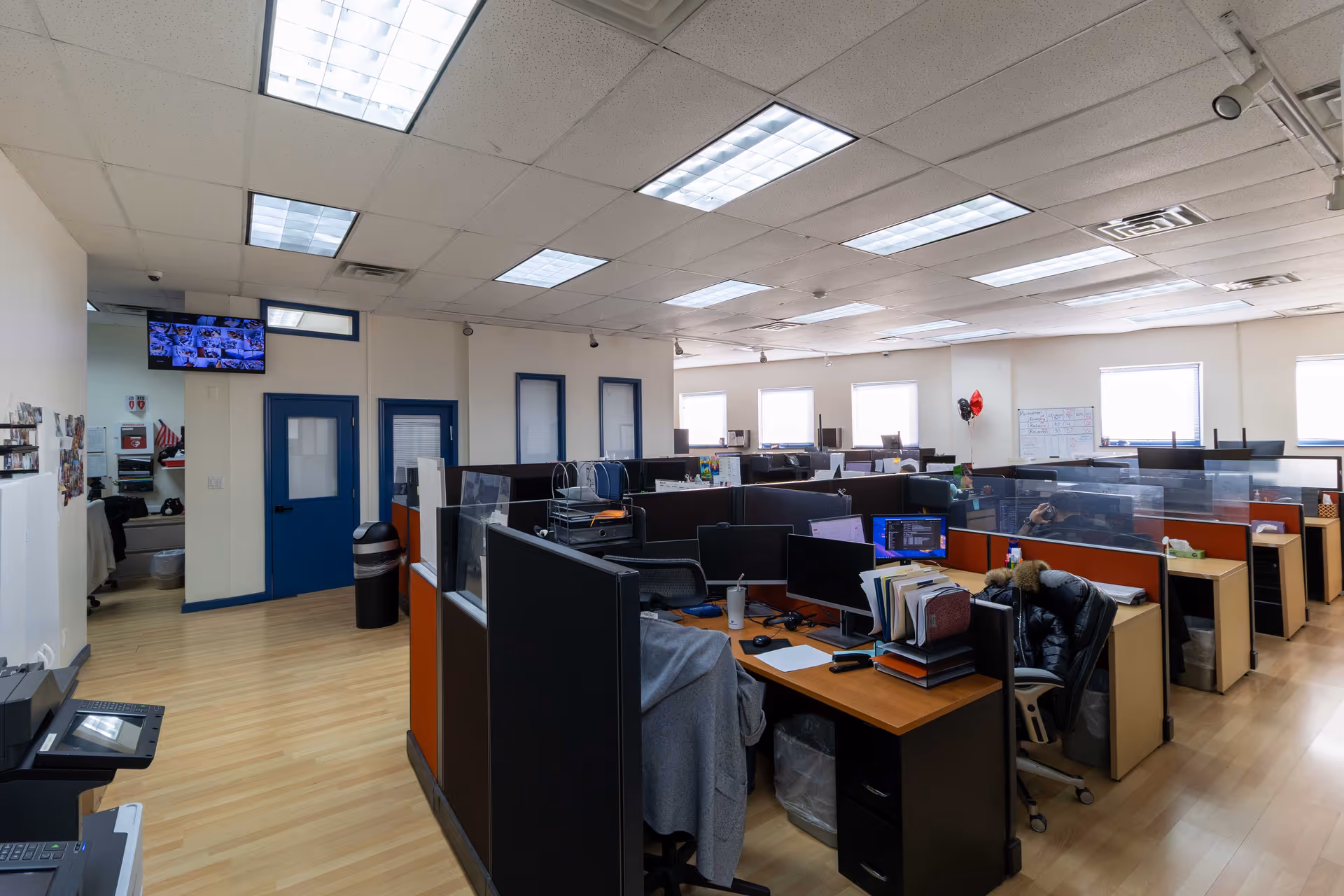 A large open-plan interior with cubicles, desks, and computer workstations.