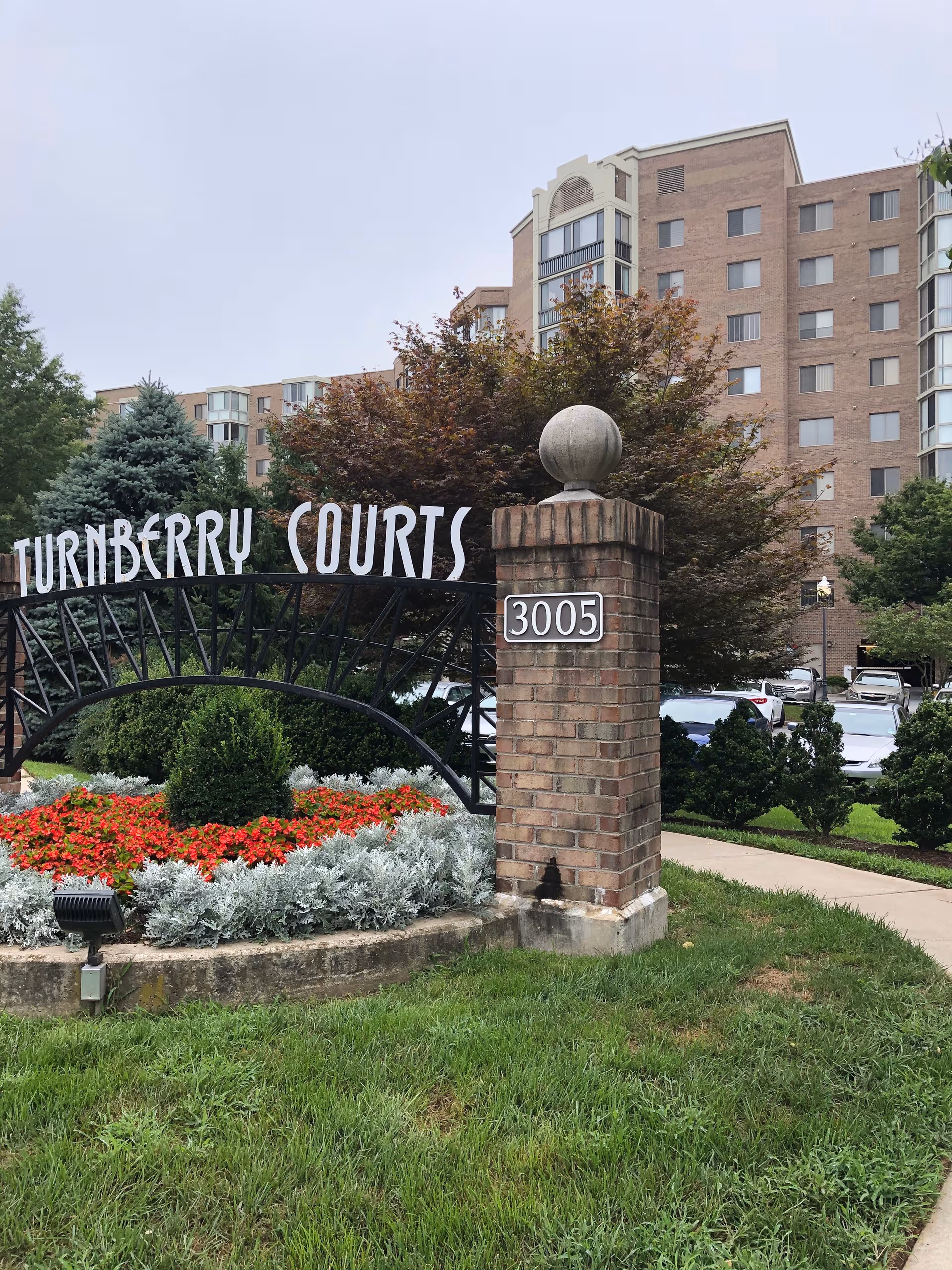 Turnberry Courts at Leisure World entrance with brick pillar and landscaped grounds.