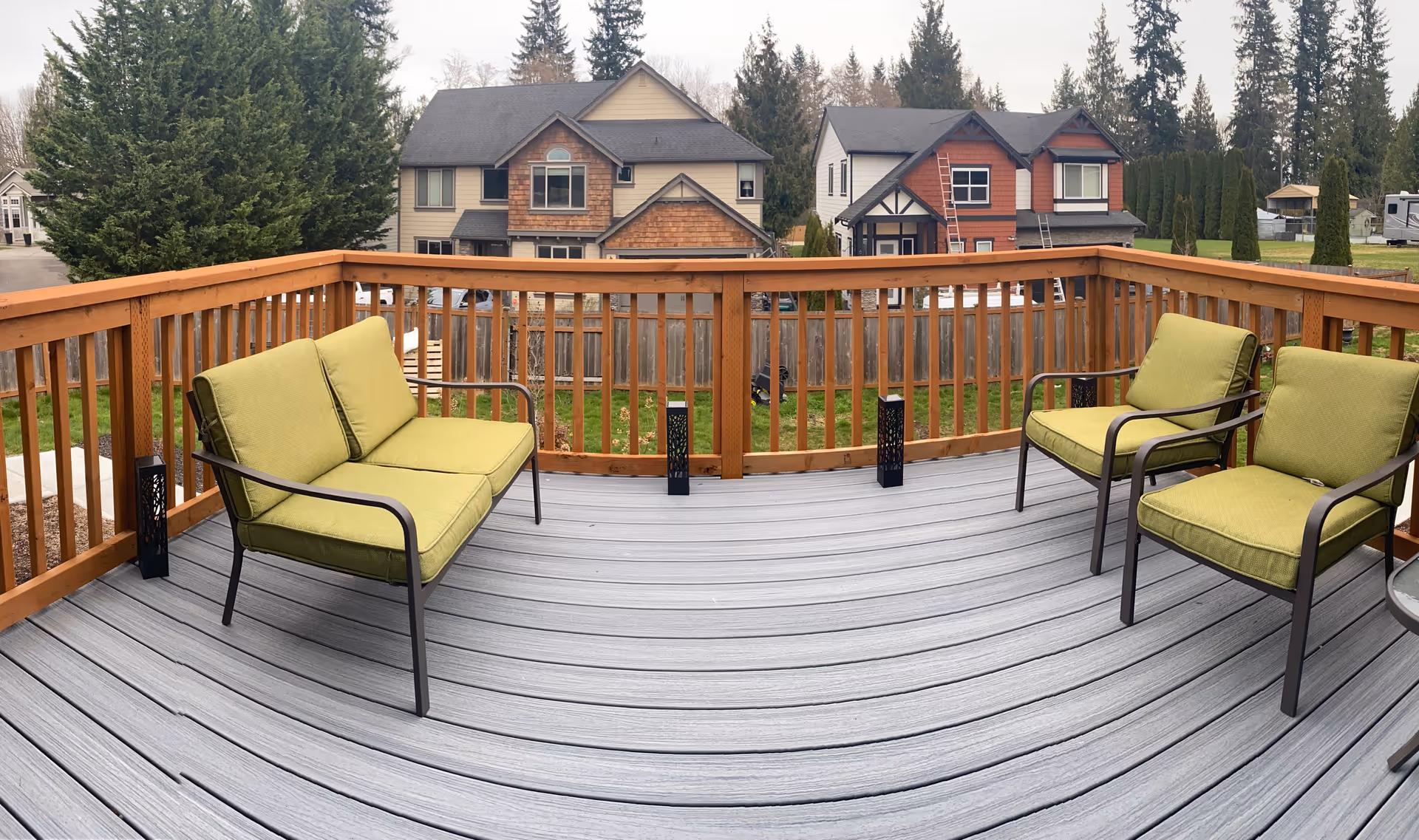 Outdoor deck at St. Thaddeus Care Home with green-cushioned seating and railing.