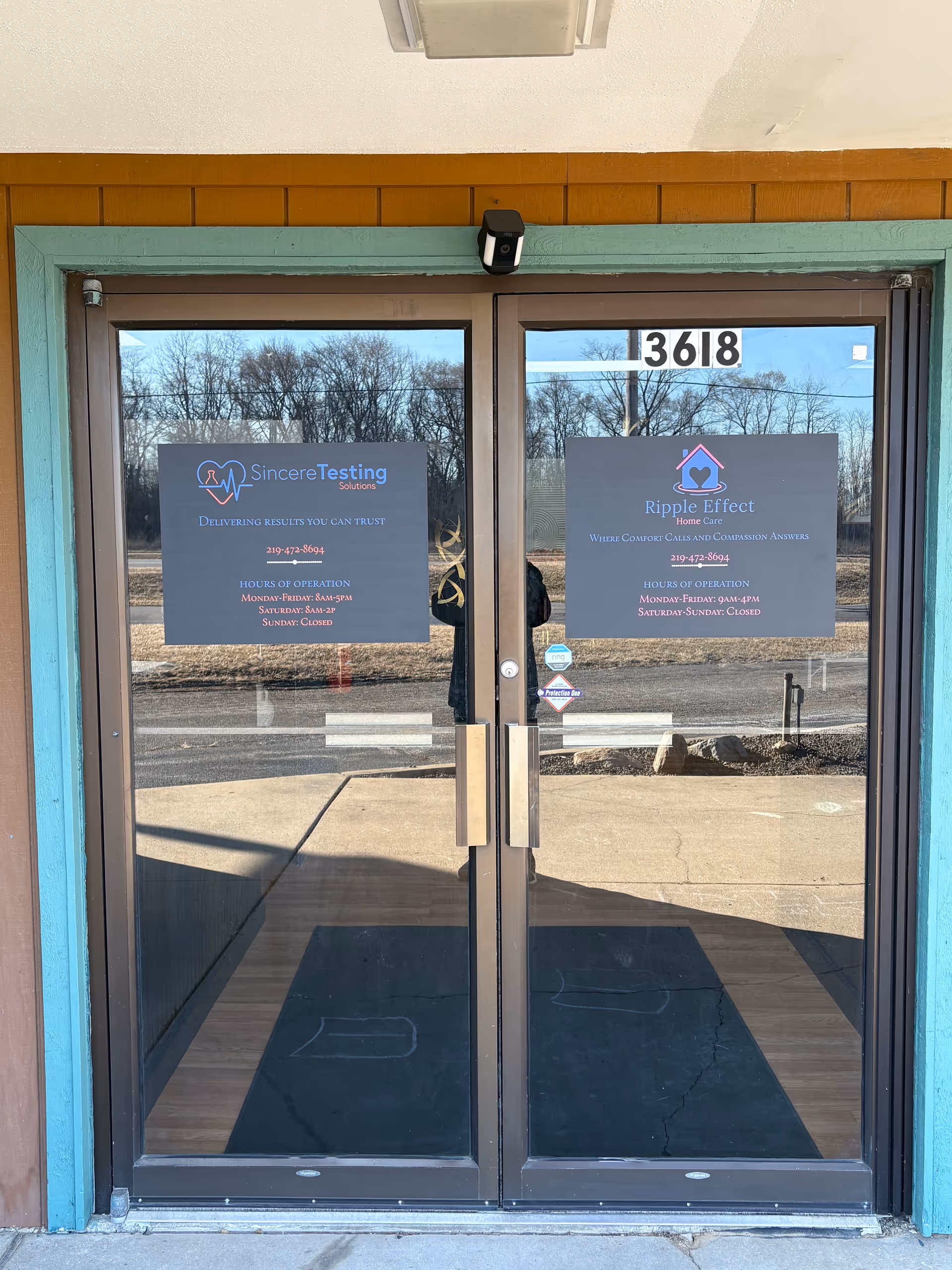 Glass double doors with Ripple Effect Home Care signage at facility entrance, 3618.