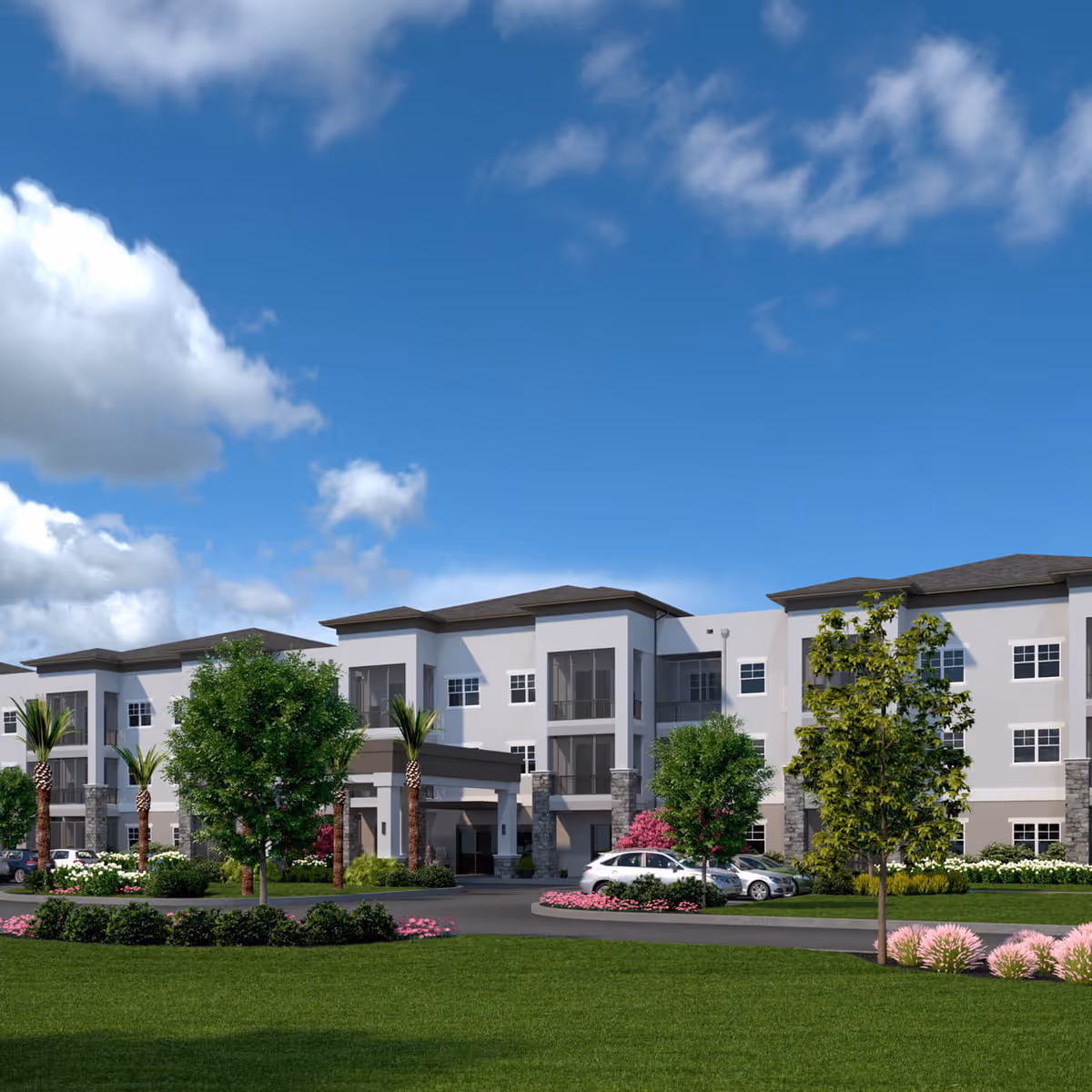 Exterior view of a modern three-story senior living facility building with a covered entrance, surrounded by landscaped greenery, trees, and parked cars under a partly cloudy blue sky.
