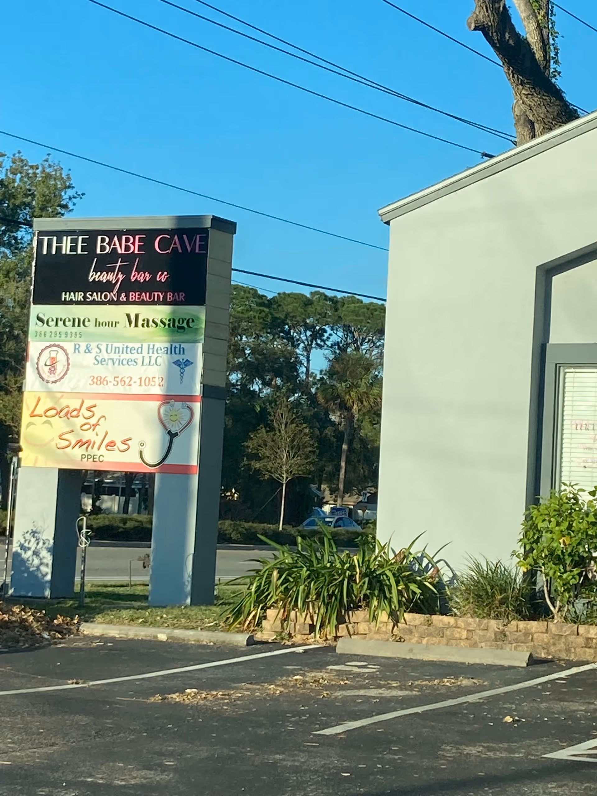 Exterior view of a building with a tall signboard advertising R&S United Health Services Medical Laboratory.