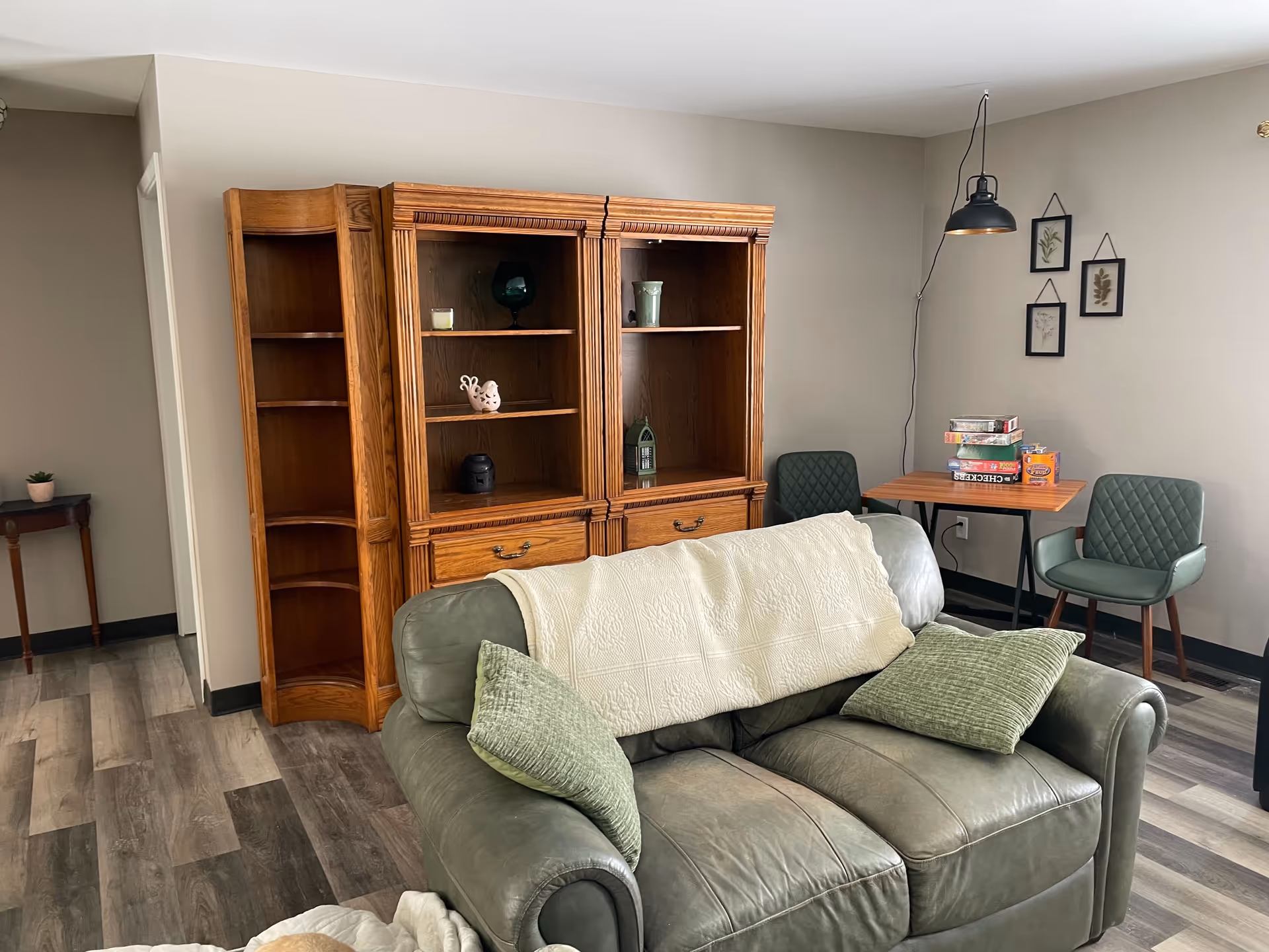 Cozy living room at Brookhaven AFC Home with sofa, cabinet, and board games.