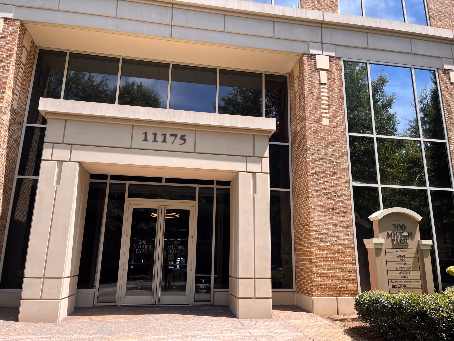 Exterior building entrance with glass doors and 11175 address plaque.