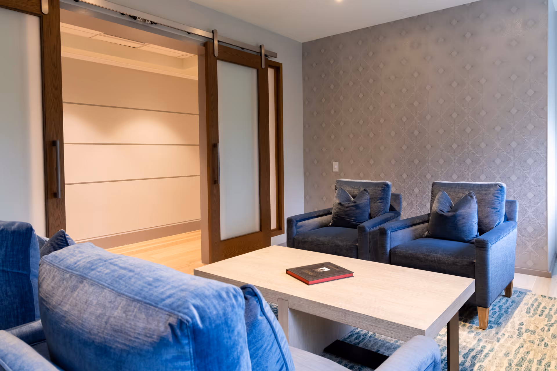 Blue upholstered seating with a light coffee table in a modern living room.
