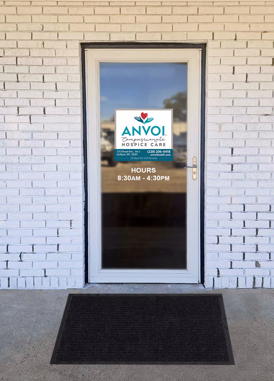 Brick exterior door with ANVOI Hospice Care sign and operating hours.