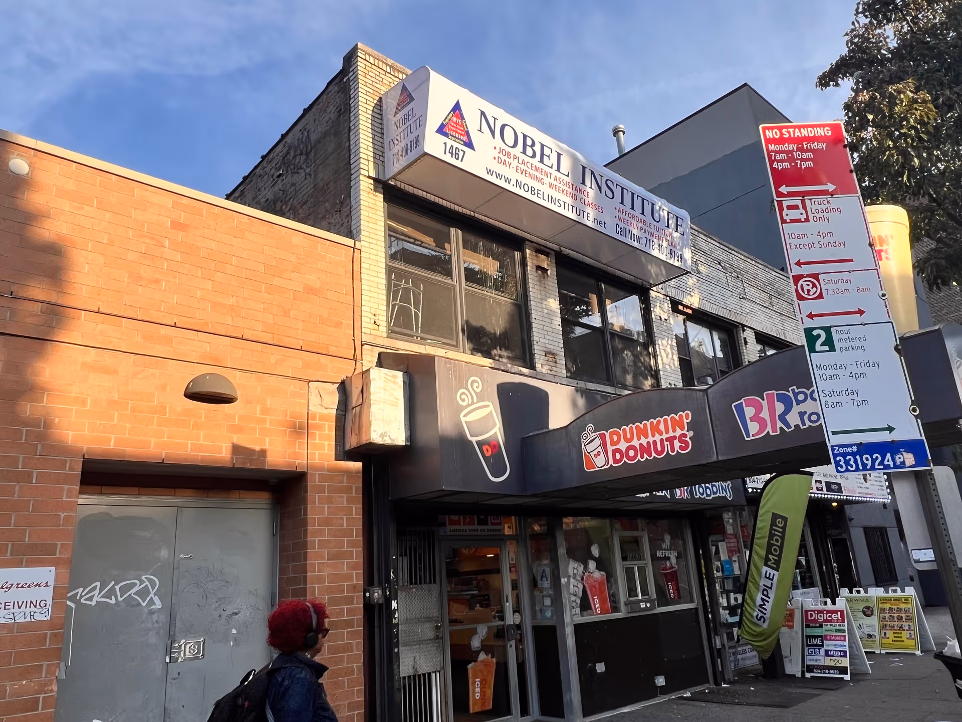 Street view of Nobel Institute building with Dunkin Donuts storefront