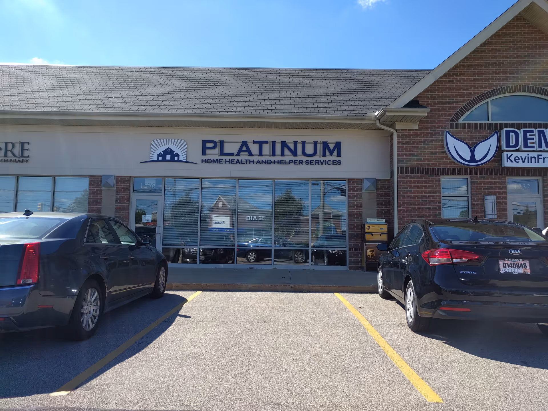 Exterior view of Platinum facility storefront with large windows and parked cars