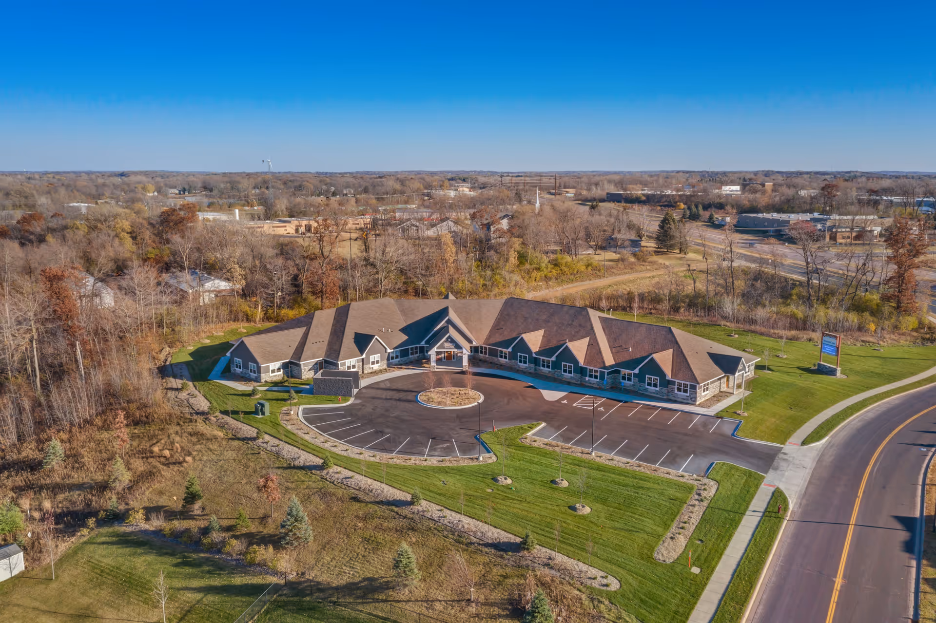 Aerial view of Suite Living Senior Care of Shakopee exterior, showing circular driveway and landscaping.