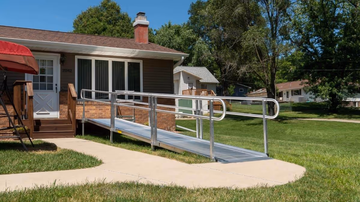 Front exterior of Mobility Plus facility with a wheelchair ramp to the entrance.