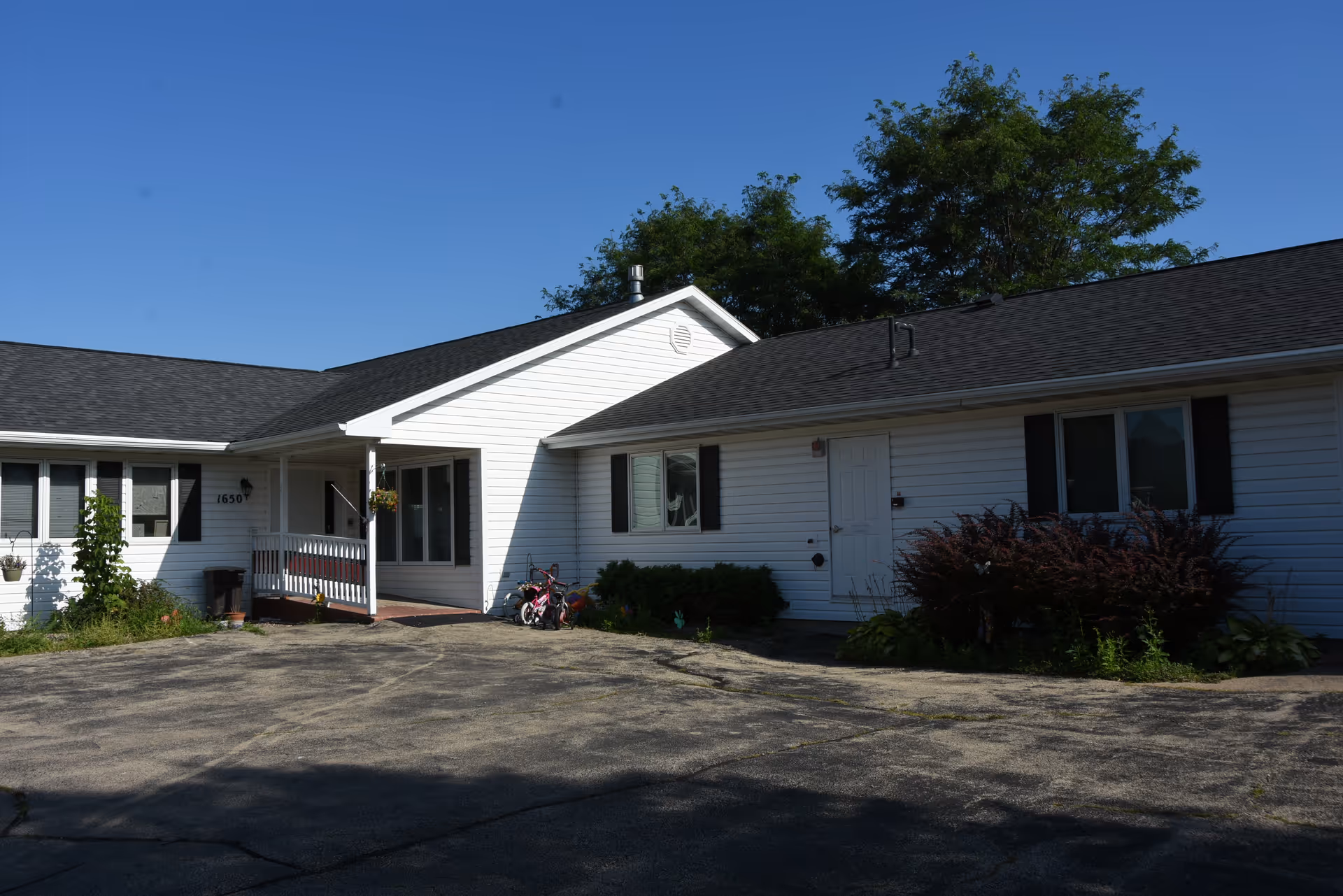 Exterior view of Bethel Assisted Living, a single-story white building with a small porch.