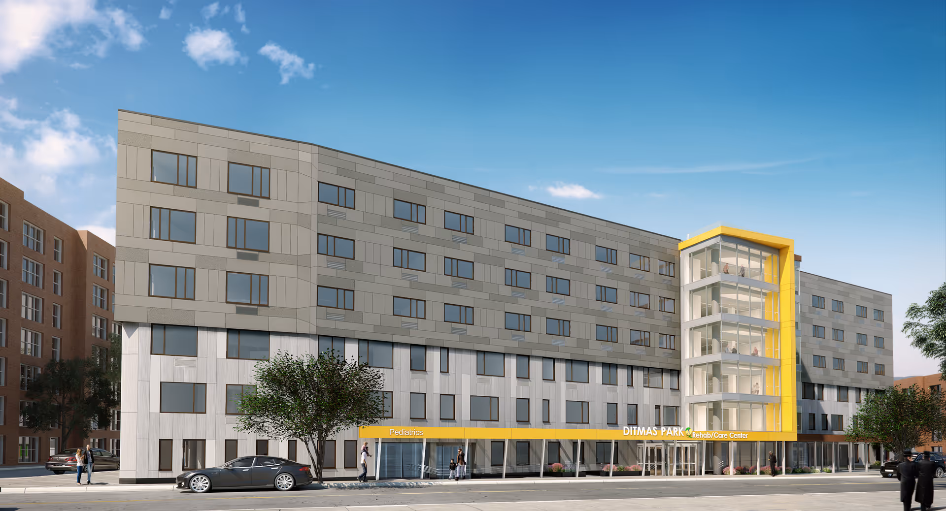 Modern multi-story senior living facility with a yellow glass stair tower and entrance.