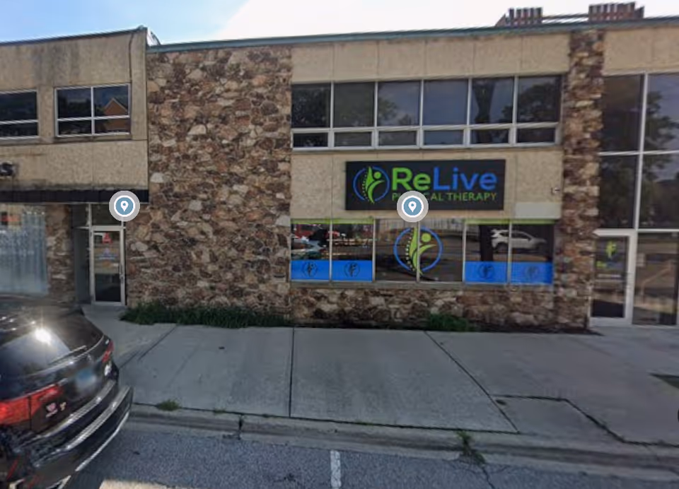 Exterior storefront with stone facade, large windows, and a ReLive Therapy sign.