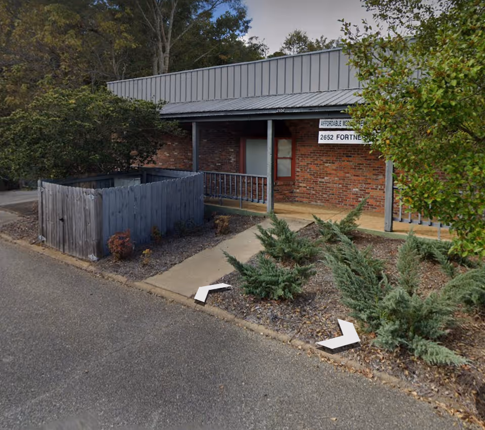 Exterior view of Affordable Medical Resources building with brick facade and entrance porch