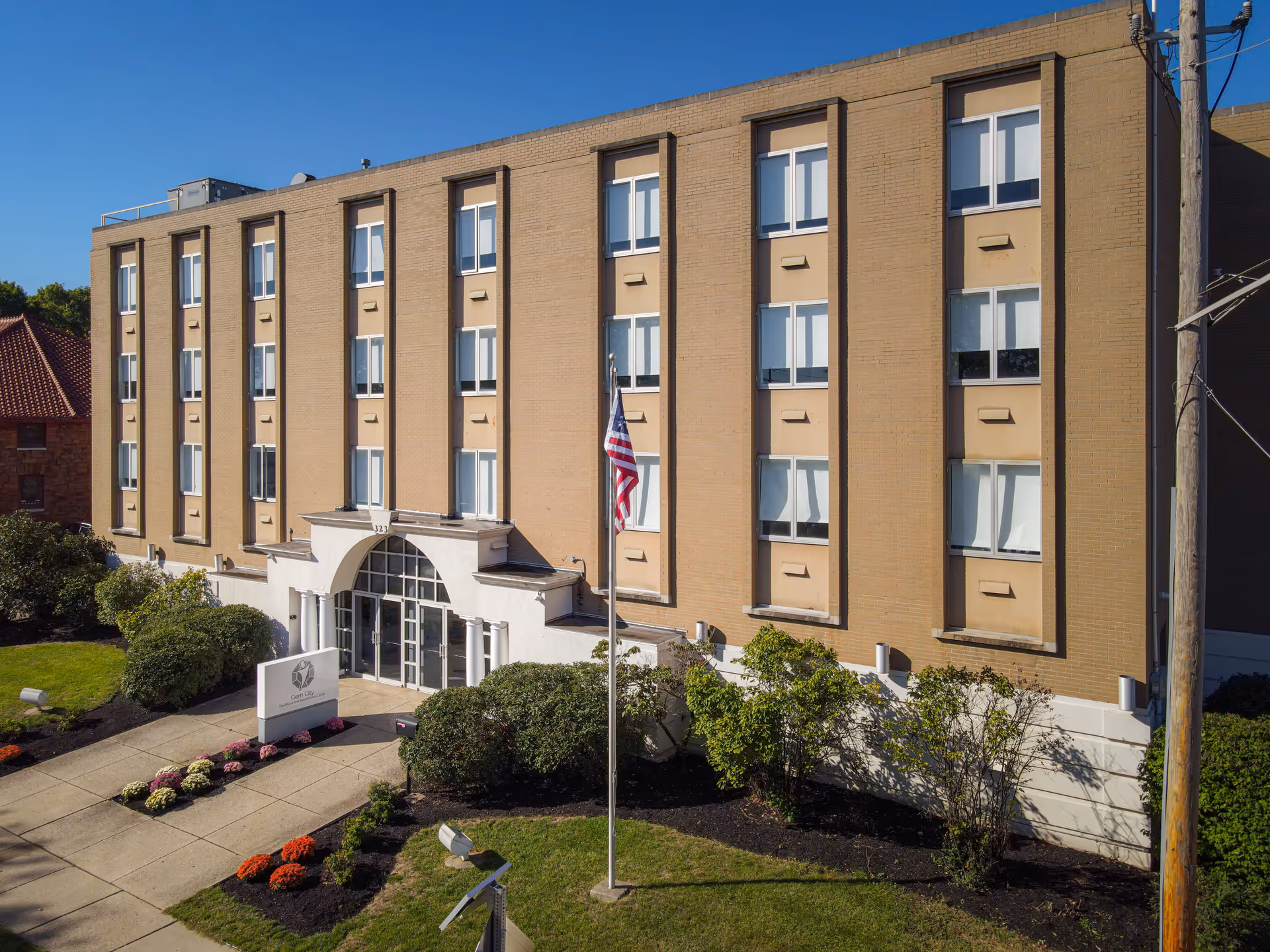 Exterior view of Gem City Nursing and Rehabilitation Center with entrance and landscaping.