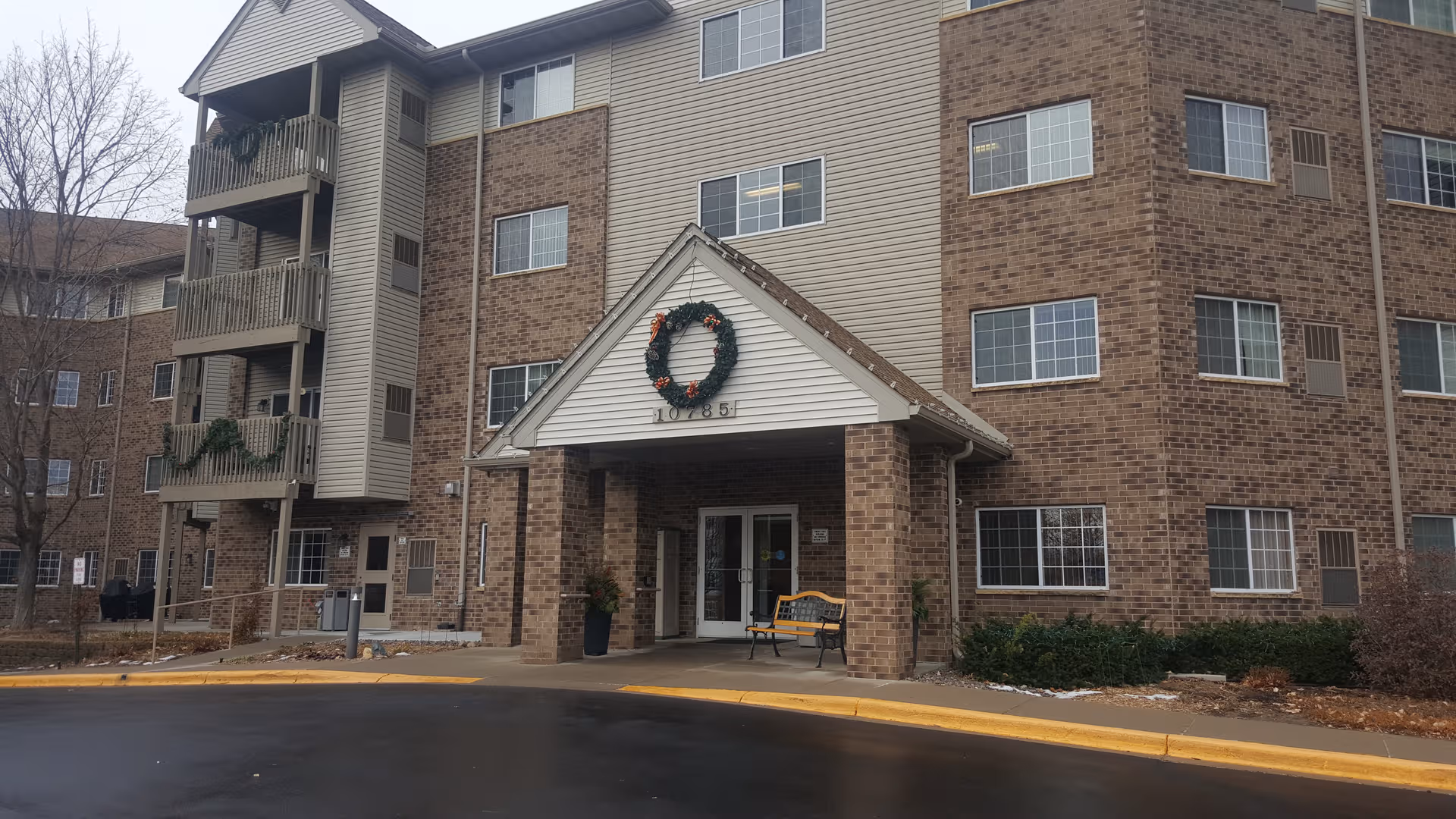 Exterior view of Valley View Cooperative building entrance with wreath and bench.