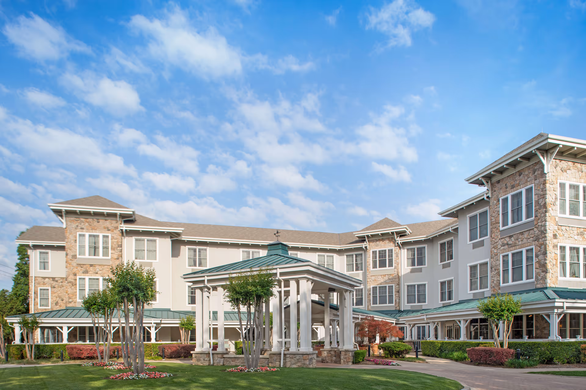 Sunrise on Hillcrest building exterior with a covered entrance and landscaped front lawn.
