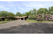 Wide view of Luther Woods Nursing and Rehabilitation Center front entrance with landscaped approach.
