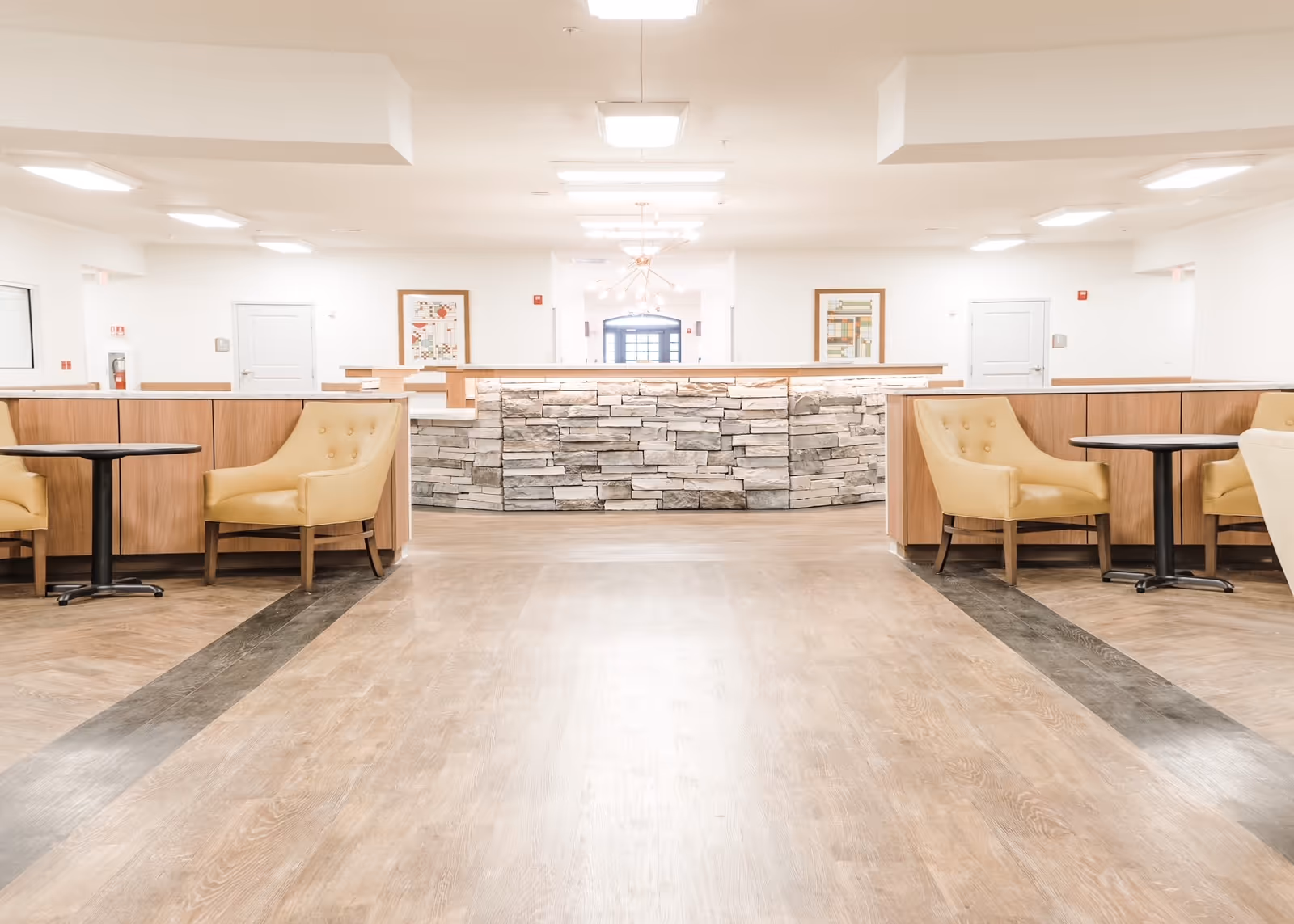 Bright interior Lakeside Health and Wellness lobby with a stone-front reception desk and seating.