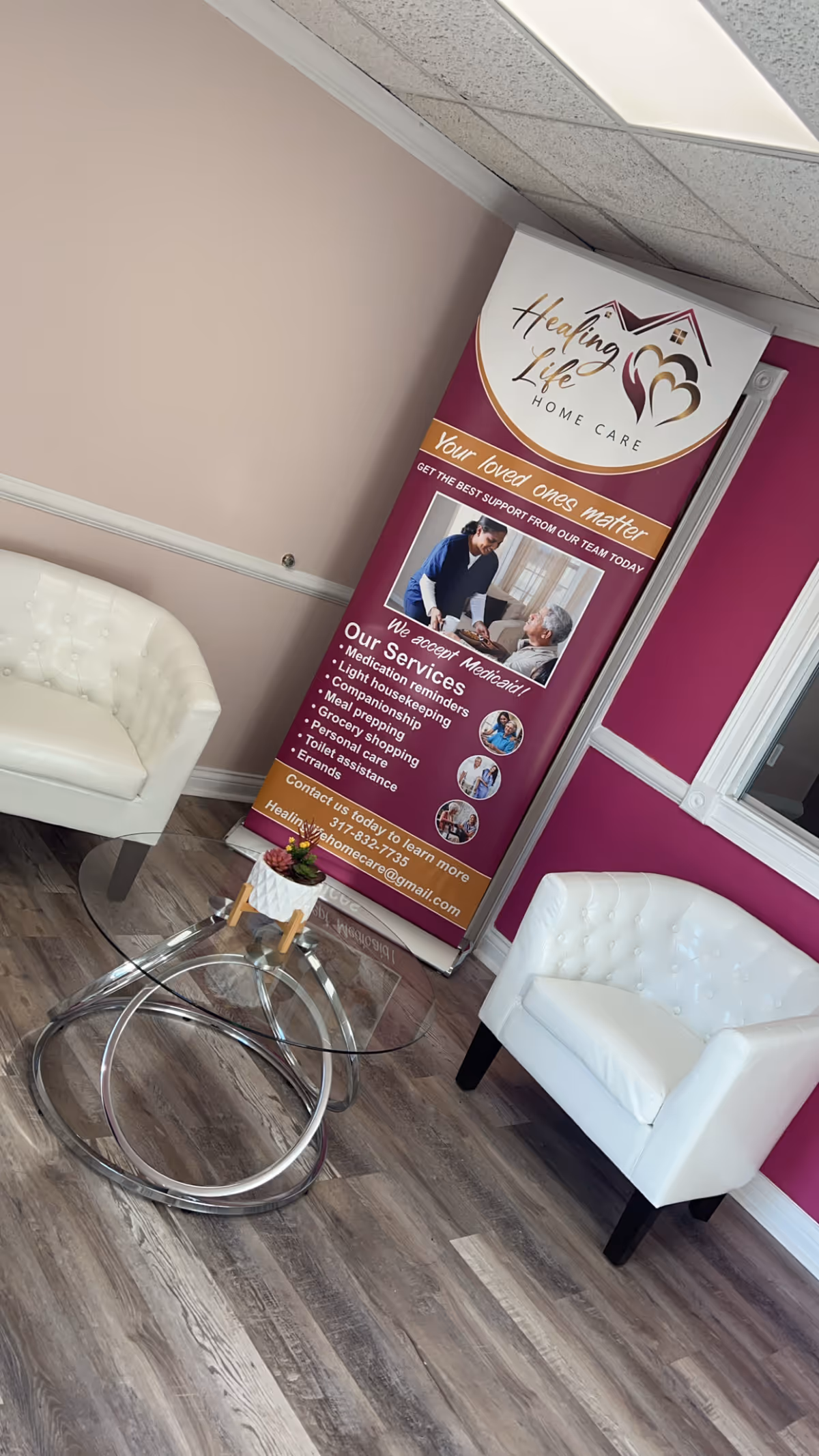 Interior waiting area with two white chairs and a Healing Life Home Care banner.