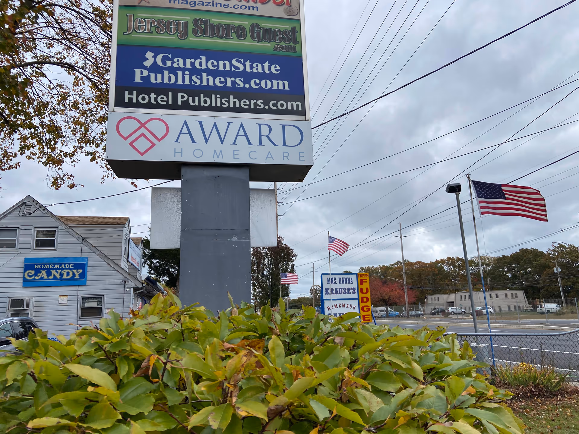 Tall Award HomeCare sign overlooks a street with a candy shop storefront.