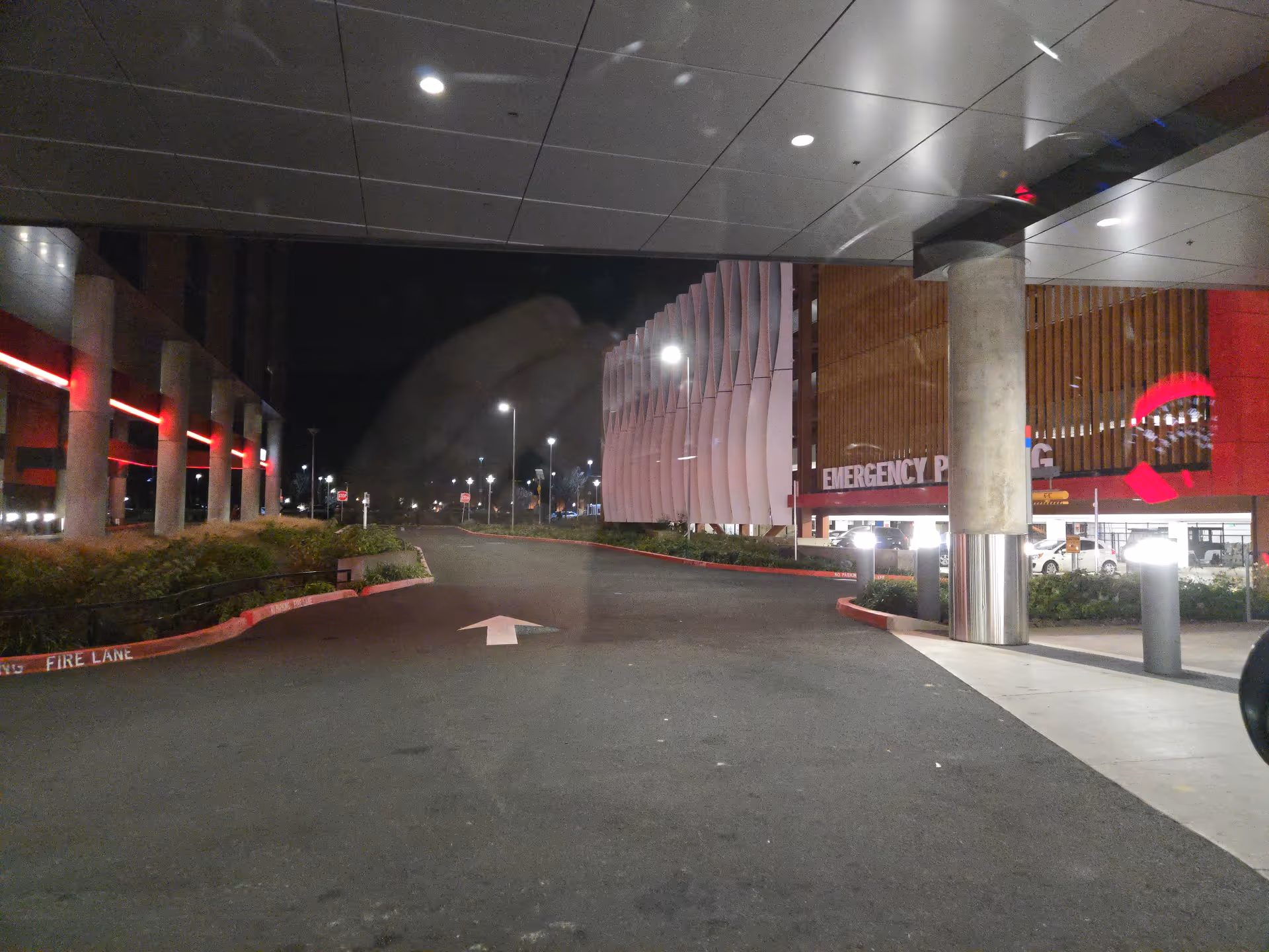 Night exterior view of Salem Health Emergency Department entrance with drive lane.
